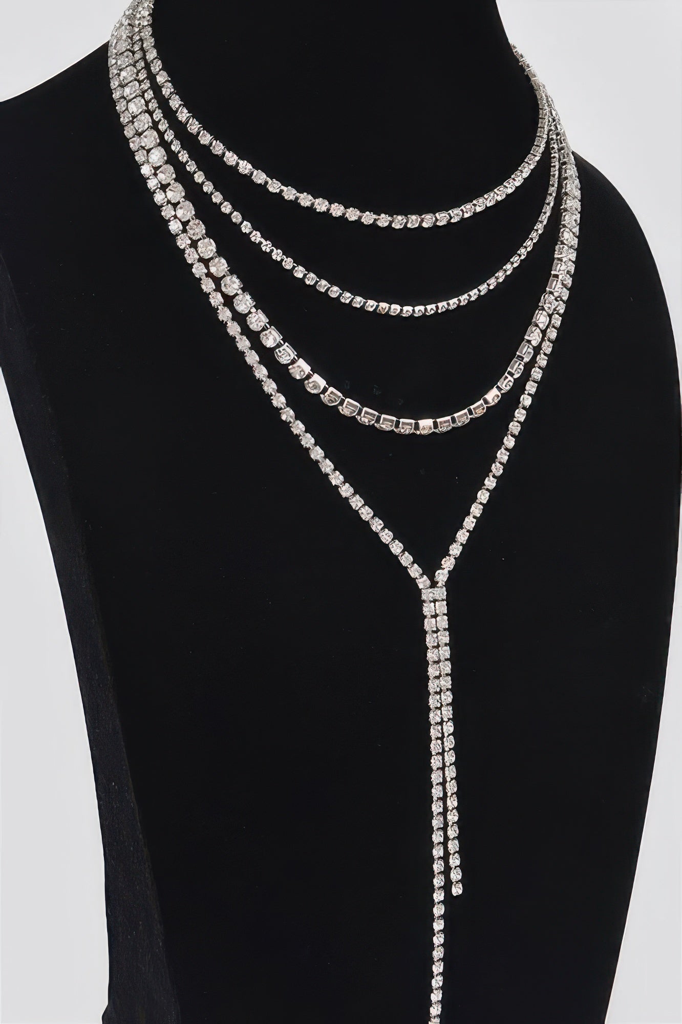Gold-tone multi-layer rhinestone necklace with 3 curved rows and long vertical drop