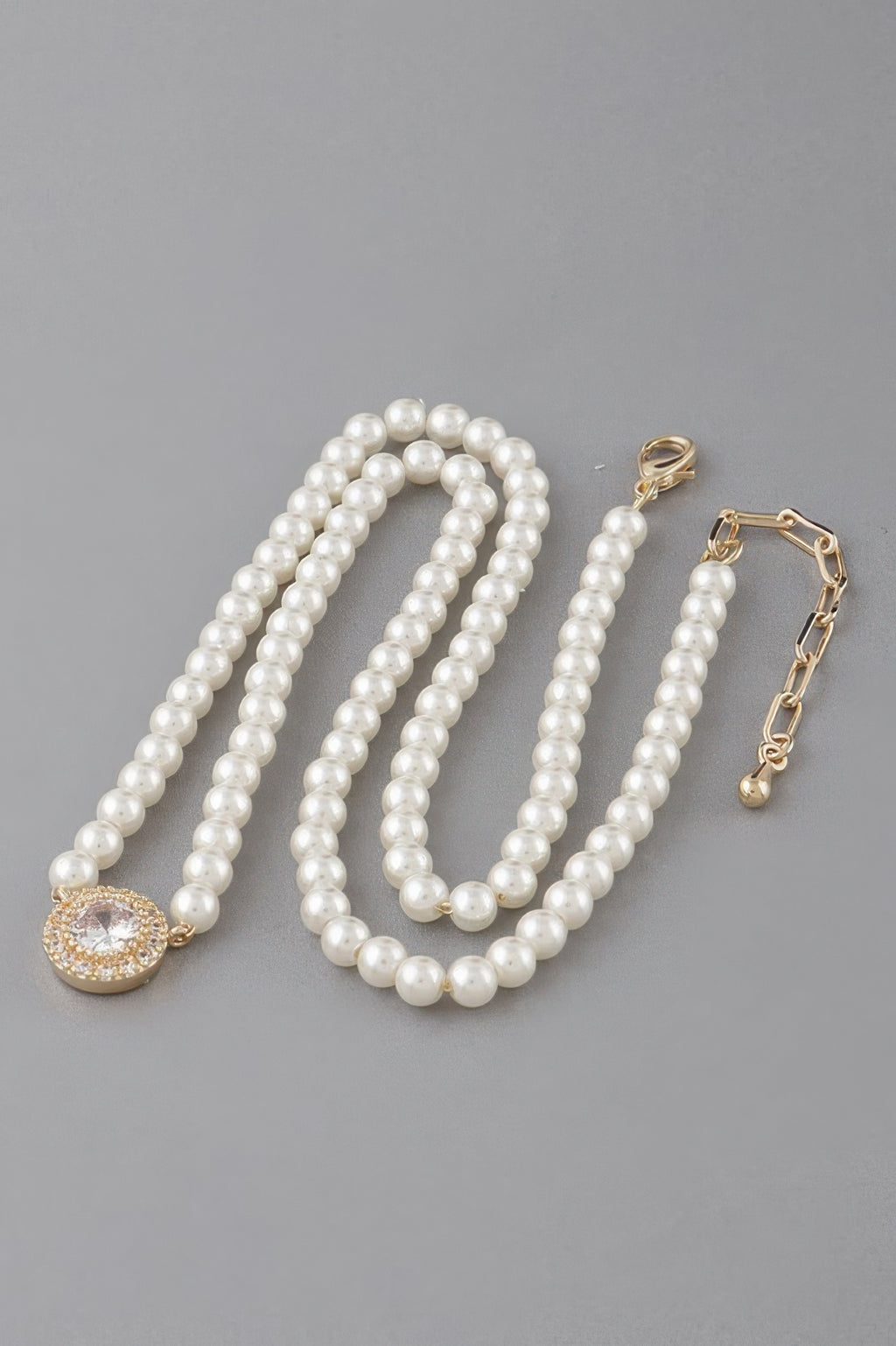 Gold-and-Cream pearl beaded necklace with round rhinestone pendant and clasp