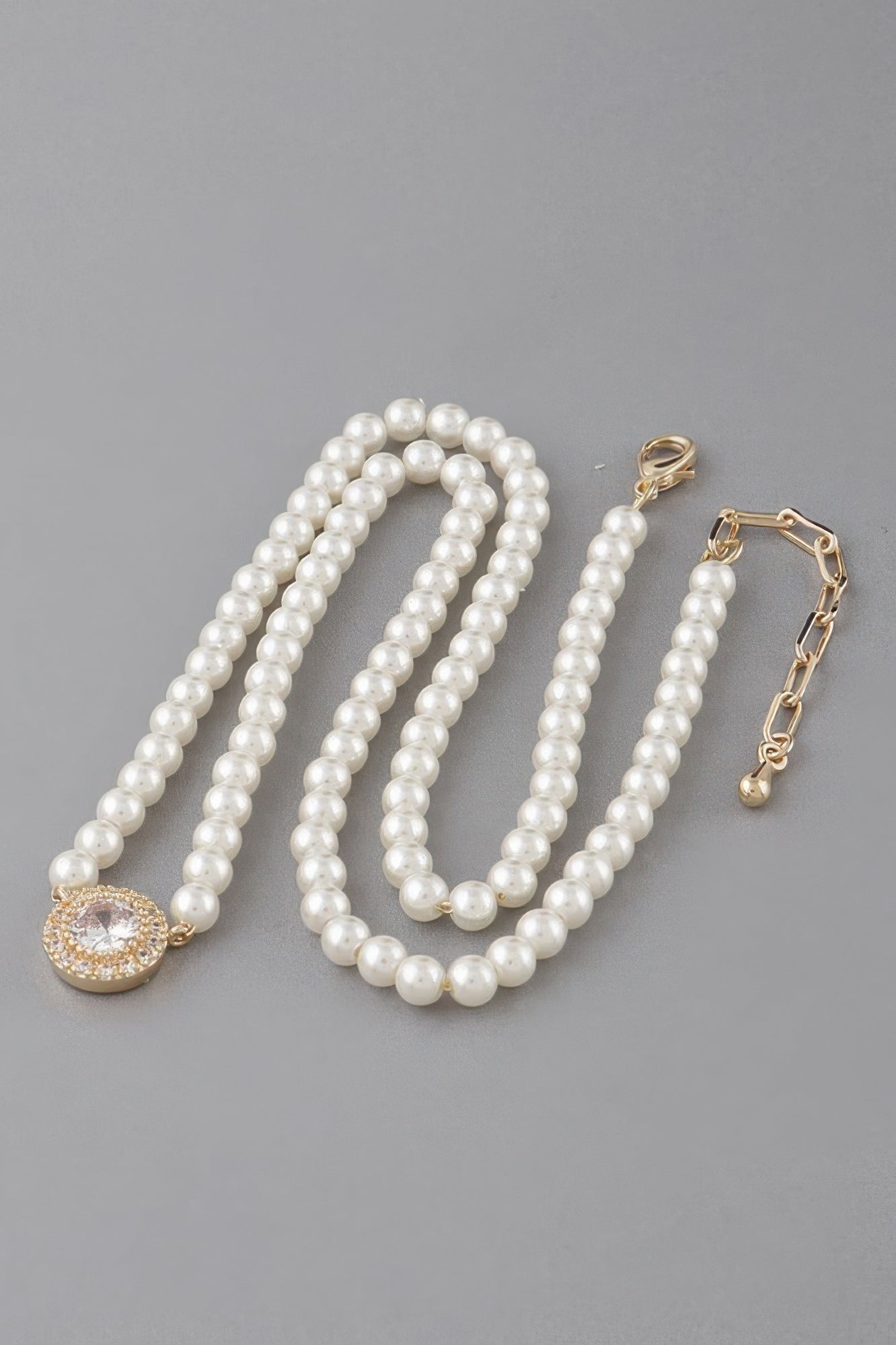 Gold-and-Cream pearl beaded necklace with round rhinestone pendant and clasp