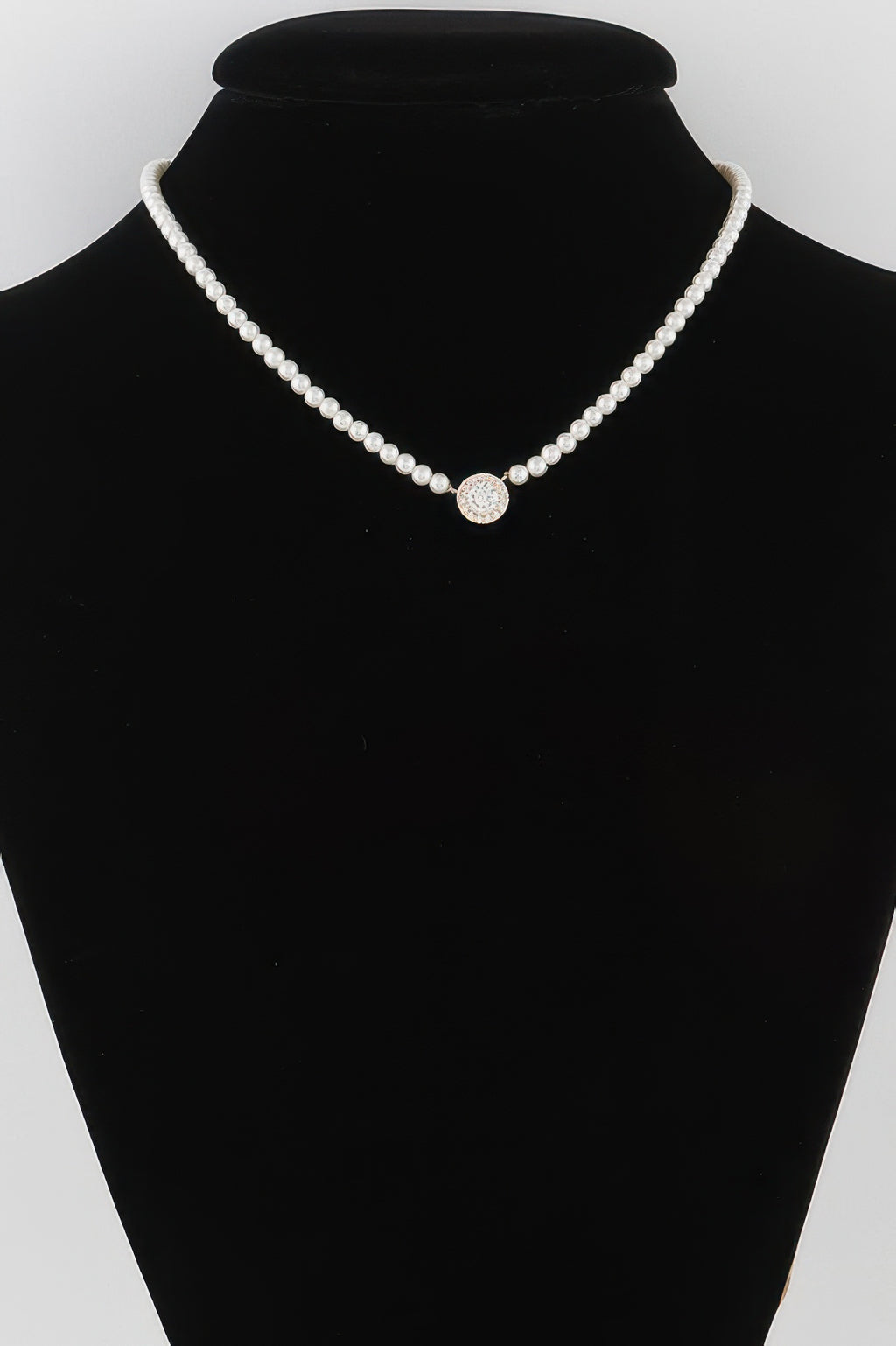 Cream pearl bead necklace with round rhinestone center on a U-shaped strand