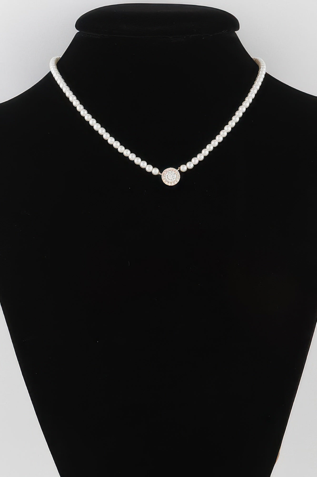 Cream pearl bead necklace with round rhinestone center on a U-shaped strand