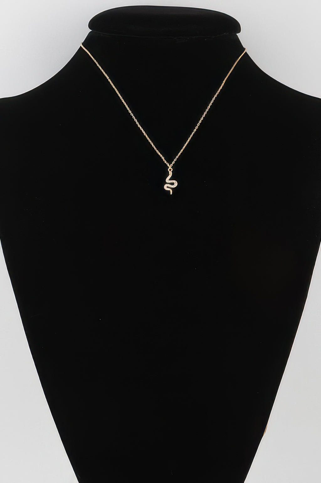 Rhinestone snake pendant necklace with gold-tone chain and small scaly charm