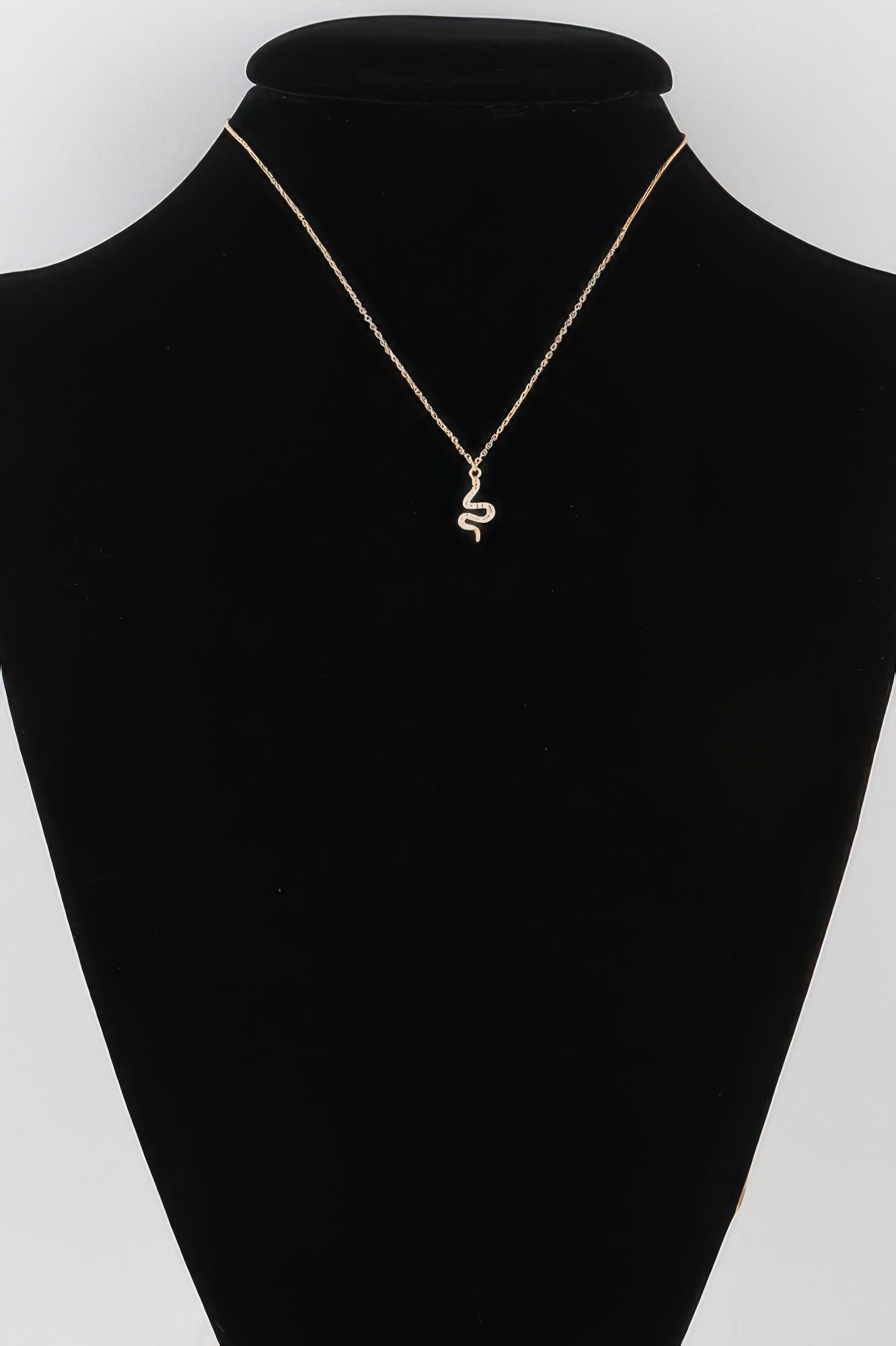 Rhinestone snake pendant necklace with gold-tone chain and small scaly charm