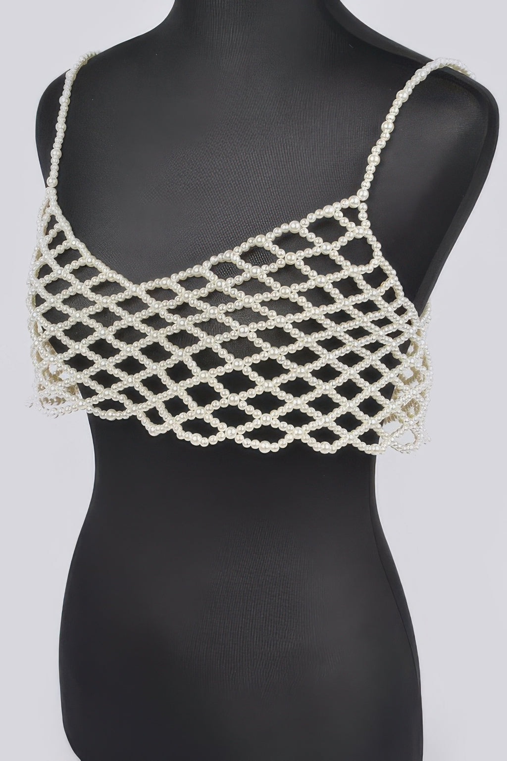 Cream faux-pearl bralette with geometric lattice straps and layered pearl fringe
