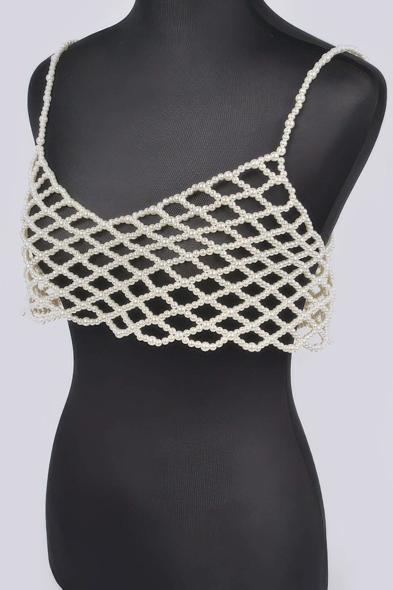Cream faux-pearl bralette with geometric lattice straps and layered pearl fringe