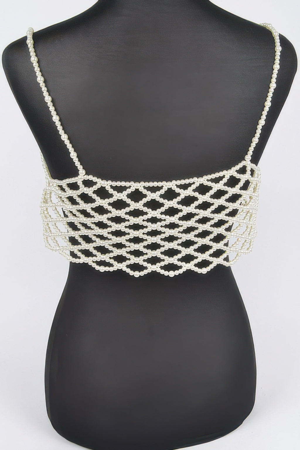 Cream faux pearl bralette with thin straps and wide crisscross pearl-mesh band