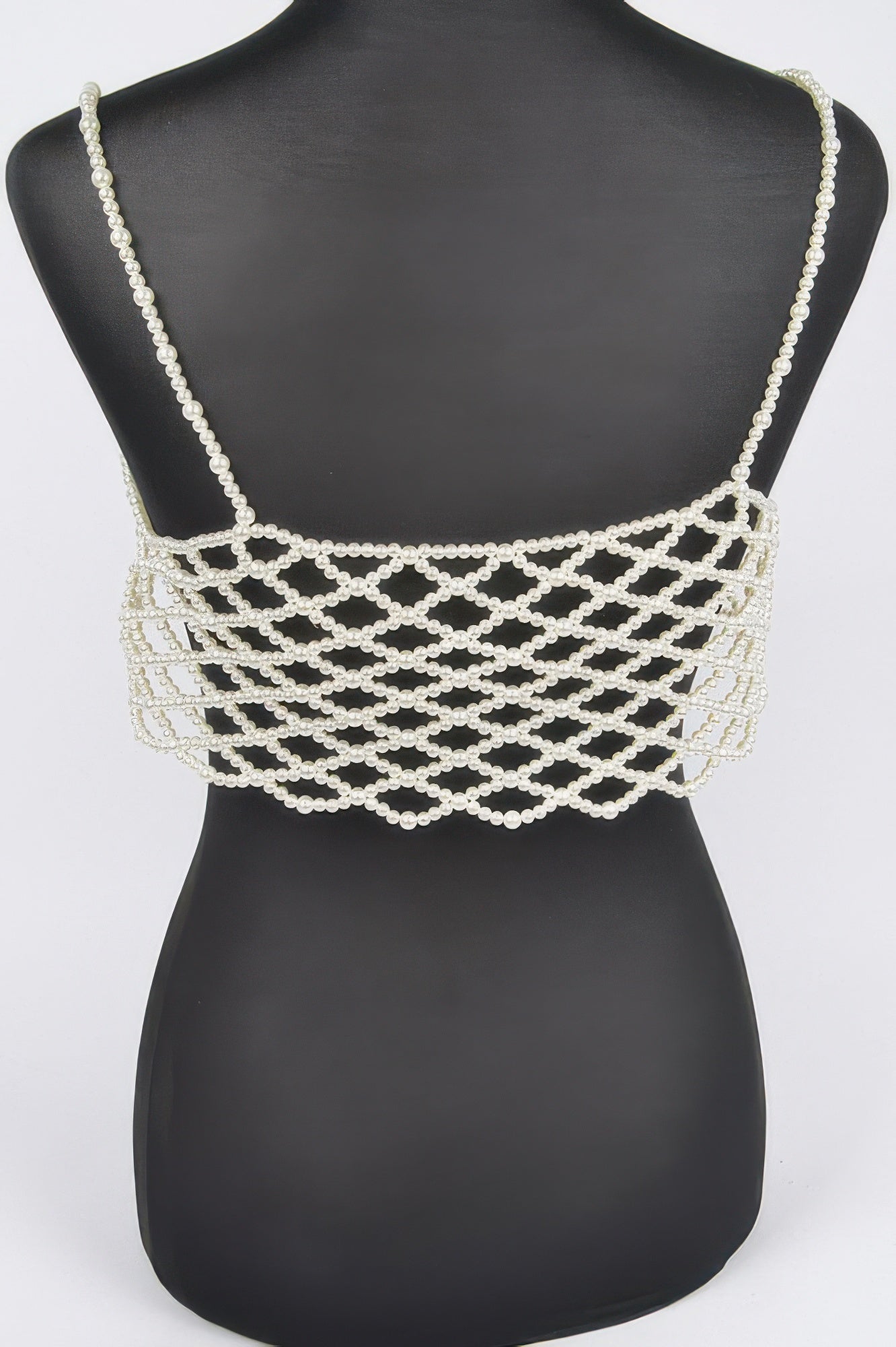 Cream faux pearl bralette with thin straps and wide crisscross pearl-mesh band