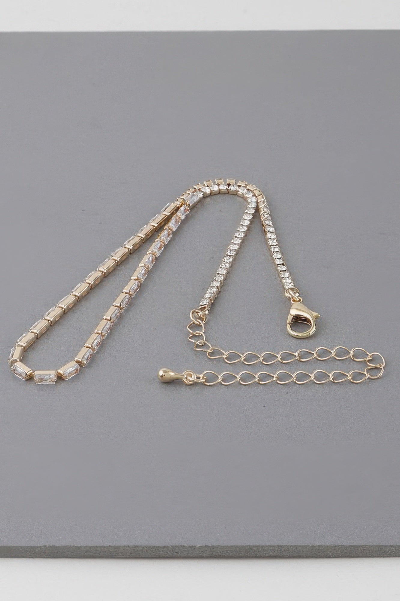 Gold-toned cubic crystal jewel necklace with heart lobster clasp and extender chain