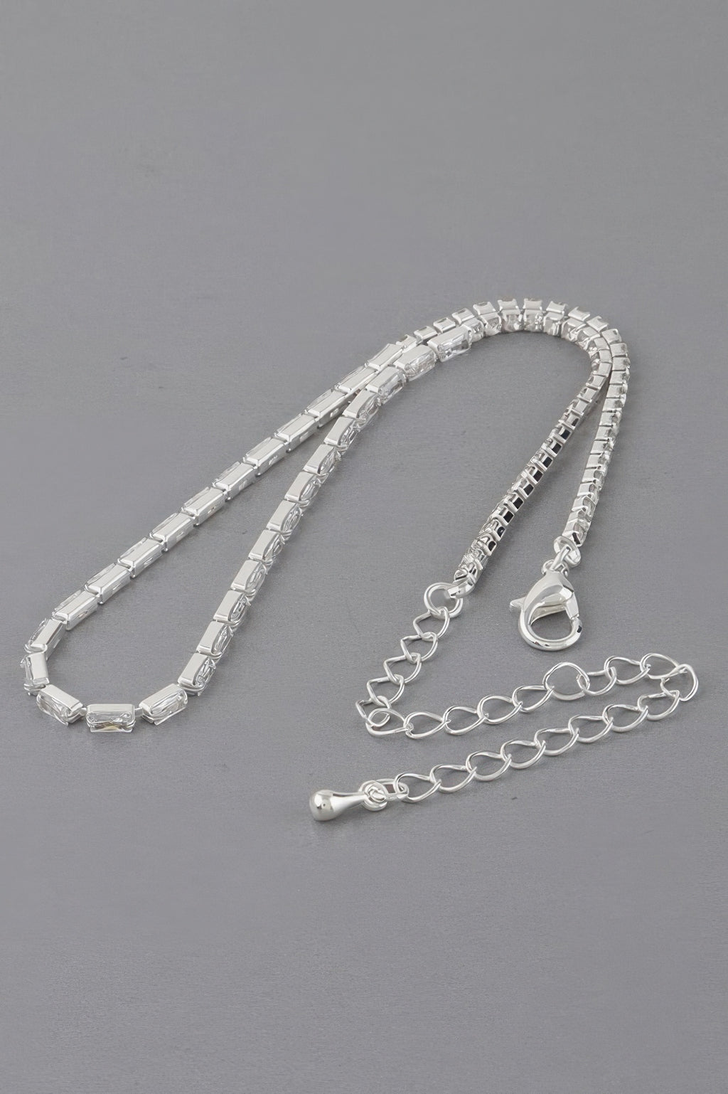 Silver-toned cubic crystal jewel necklace with heart clasp and linked extender chain