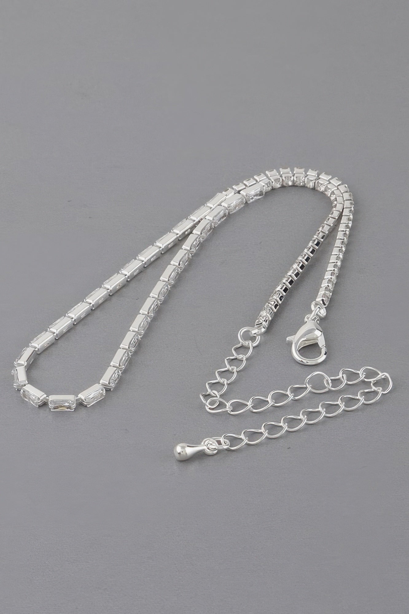 Silver-toned cubic crystal jewel necklace with heart clasp and linked extender chain