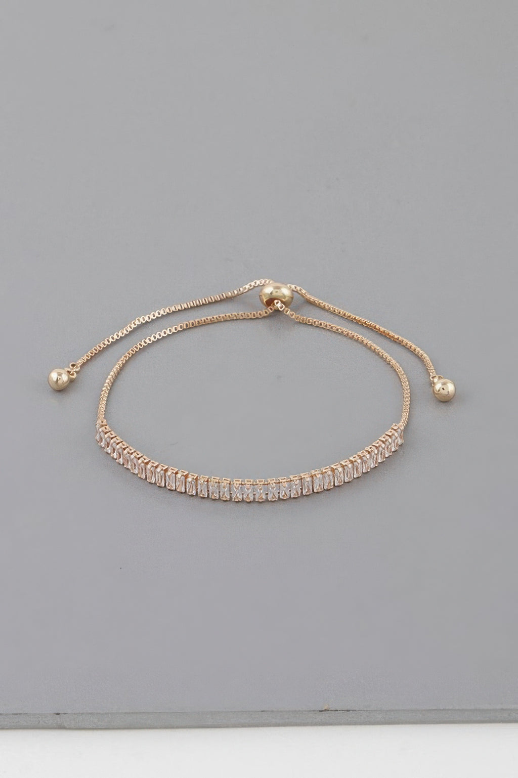 Classic rhinestone adjustable bracelet in gold with clear stones and bead ends