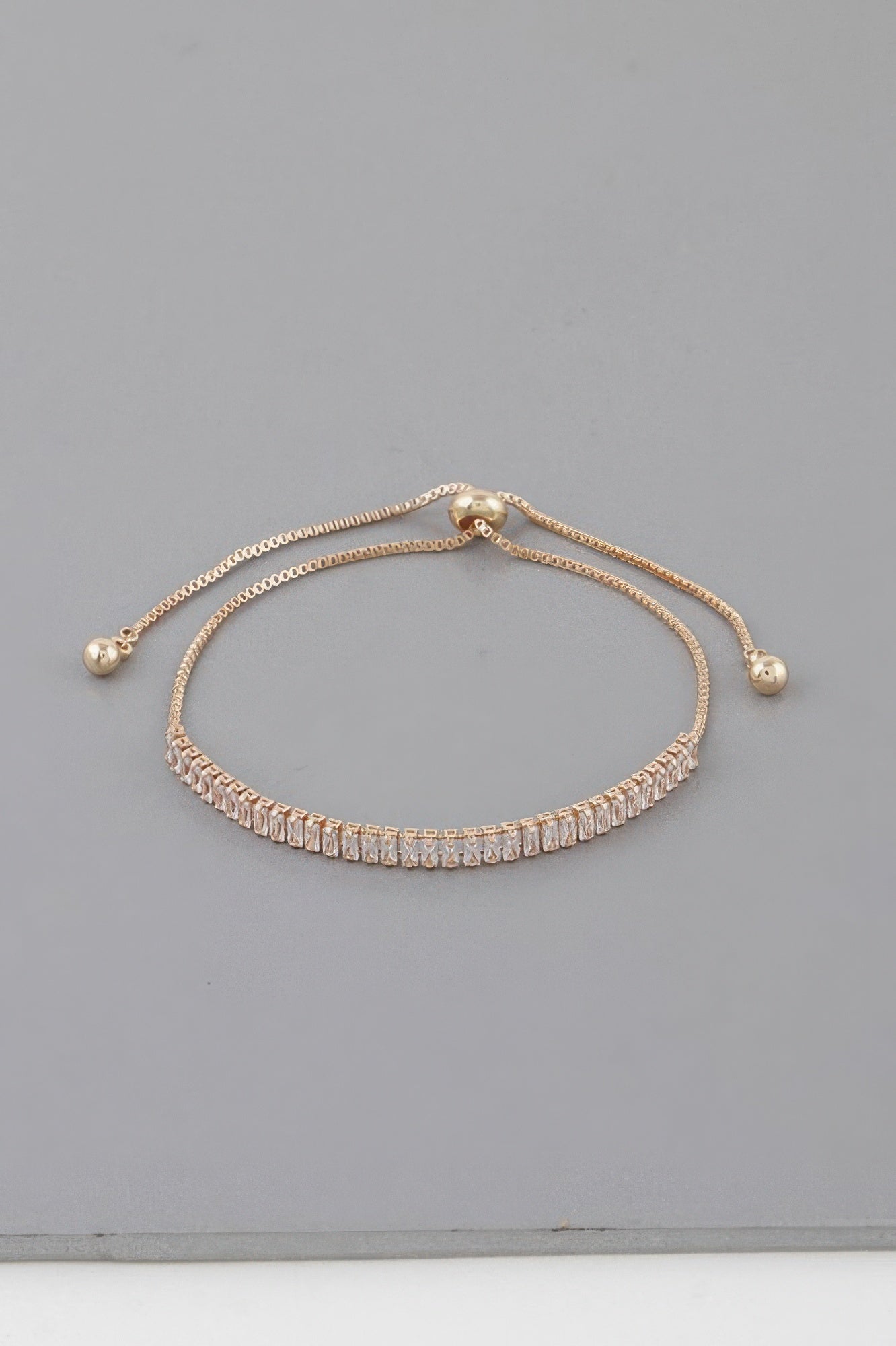 Classic rhinestone adjustable bracelet in gold with clear stones and bead ends