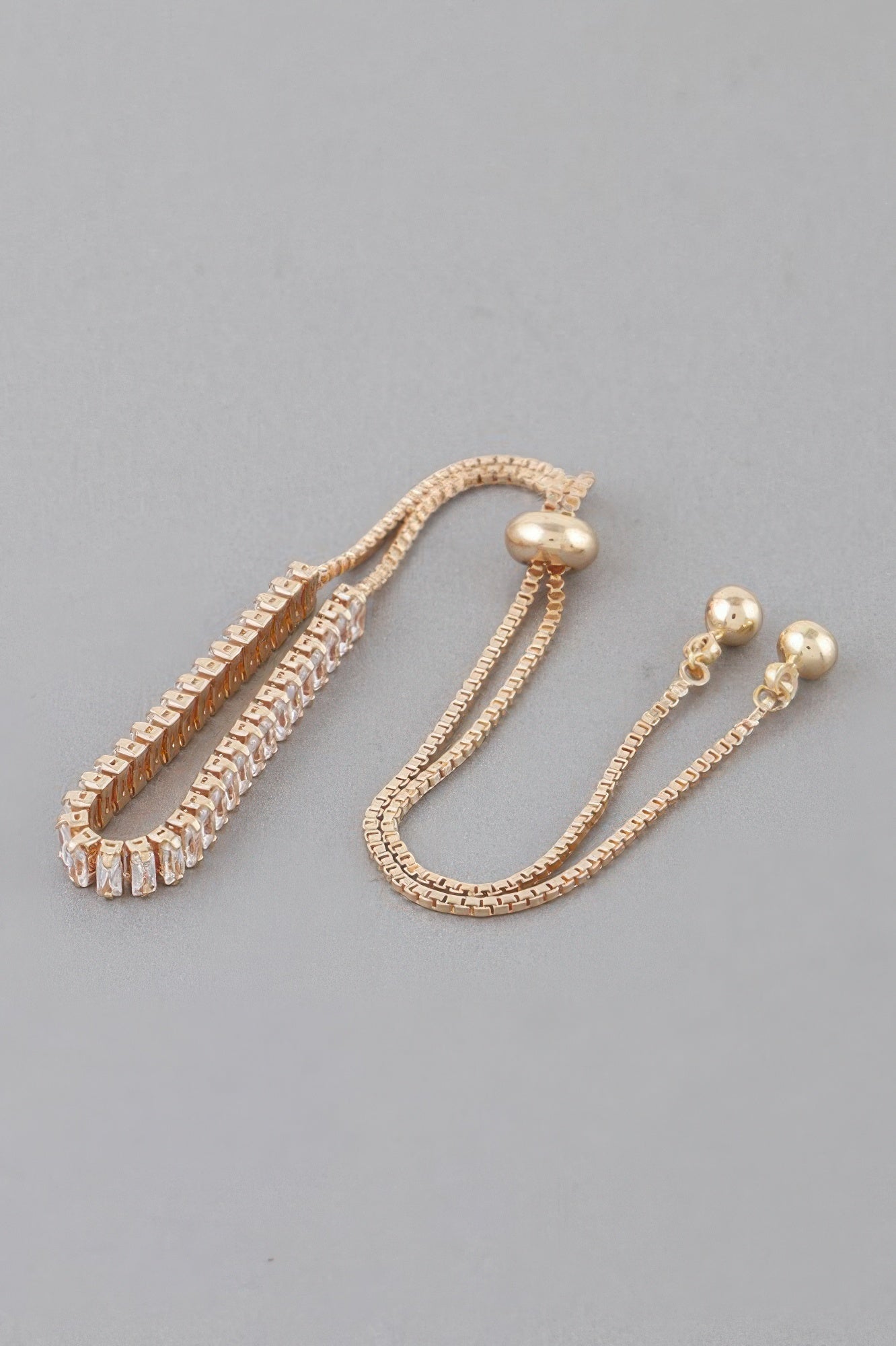 Gold rhinestone bracelet with stacked crystal bands and adjustable chain, ball clasp