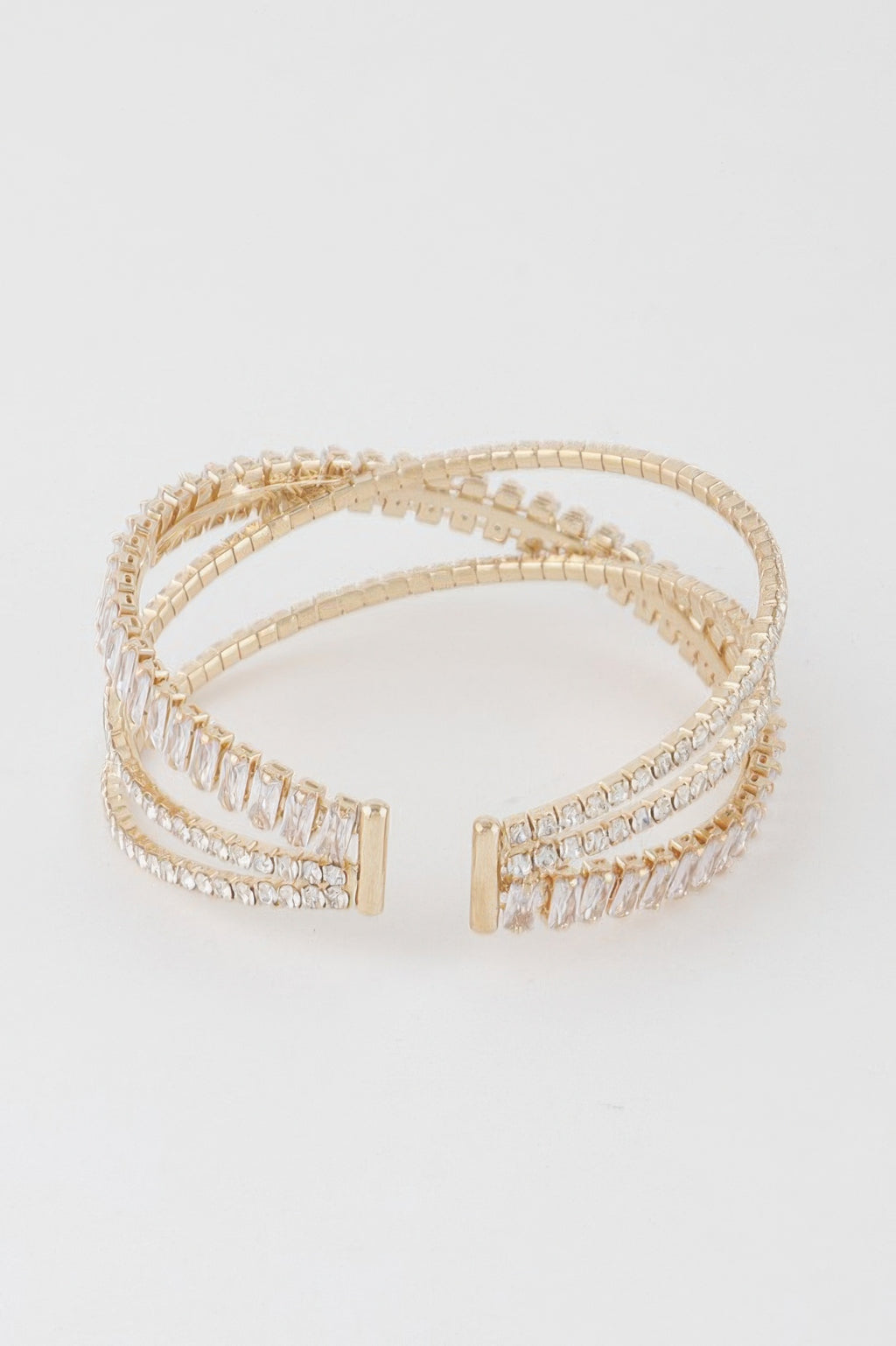 Triple crystal cuff bracelet with gold-tone clasp ends and clear baguette crystals