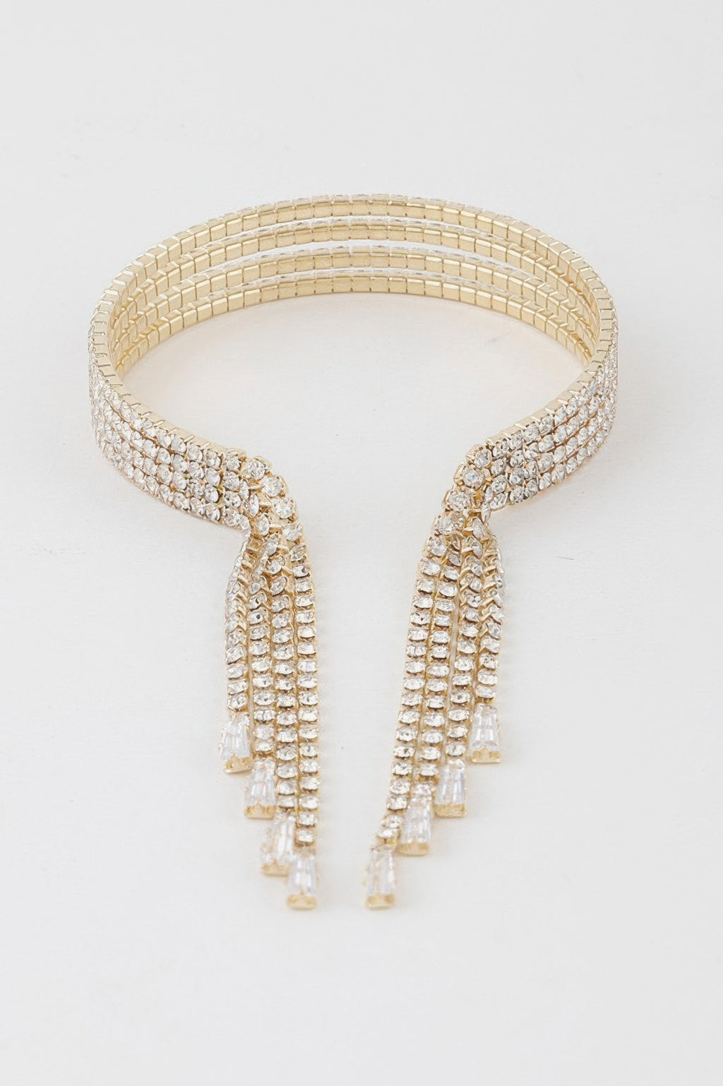 Gold-clear rhinestone cuff bracelet with stacked rows and two long drop fringe panels