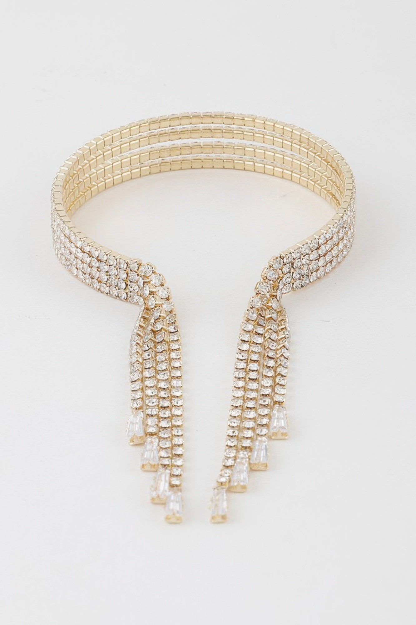 Gold-clear rhinestone cuff bracelet with stacked rows and two long drop fringe panels