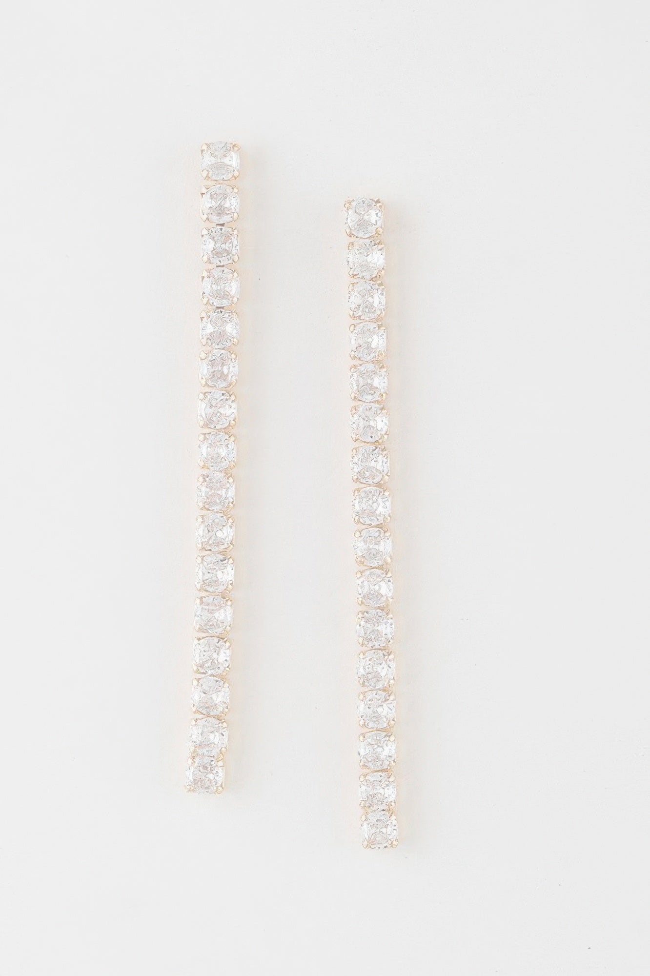 Gold-tone rhinestone bar drop earrings with clear stones, long vertical design