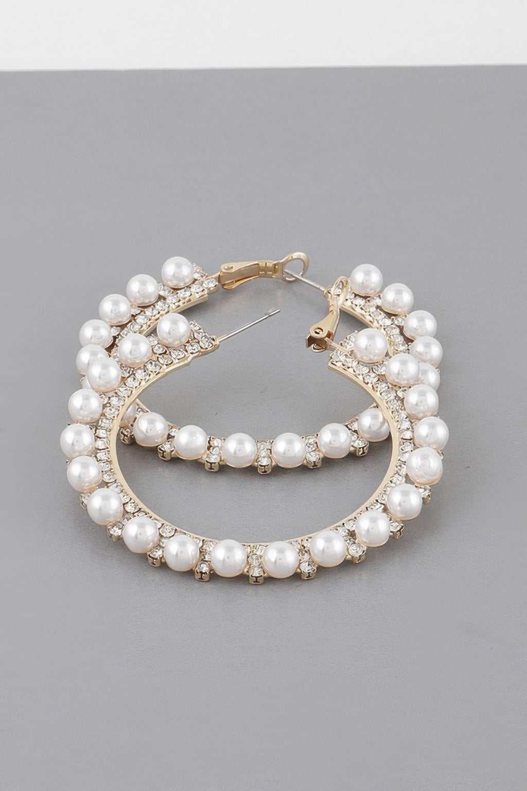 Gold-tone pearl hoop earrings with rhinestone trim and pearl row drop