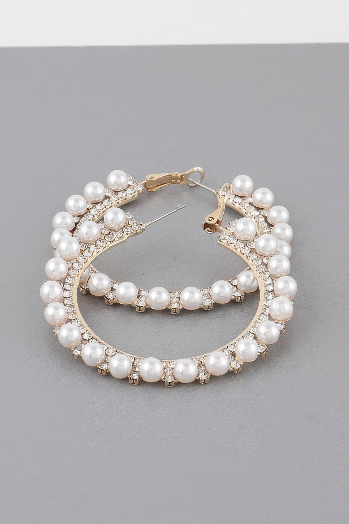 Gold-tone pearl hoop earrings with rhinestone trim and pearl row drop