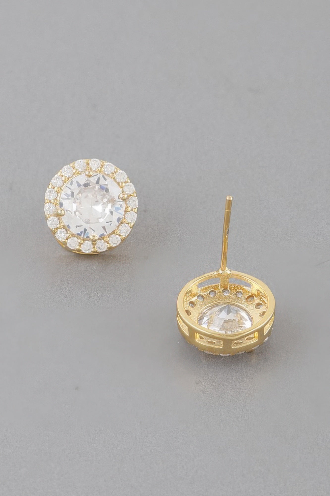 Gold round stud earring, visible pin and circular halo setting
