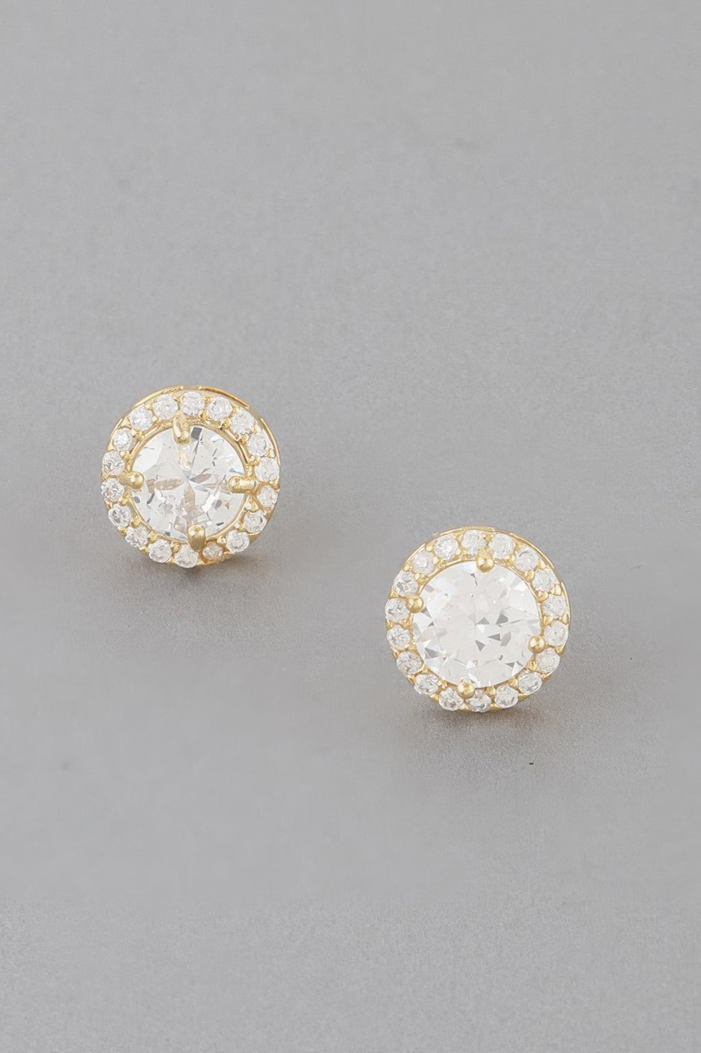 Gold round jeweled stud earrings with clear center stone and halo of crystals