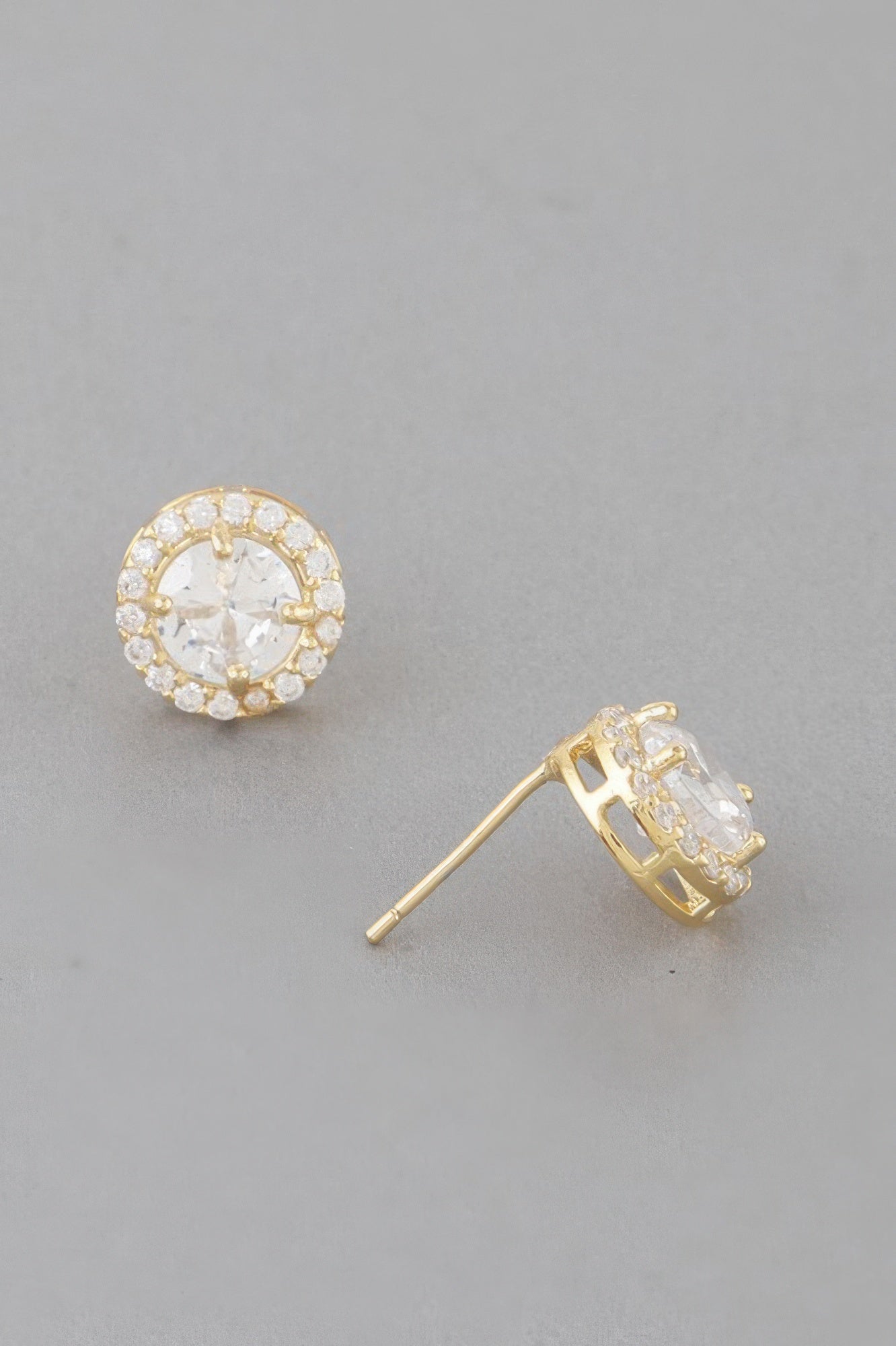 Gold round stud earring with clear halo stones; back post and clasp visible