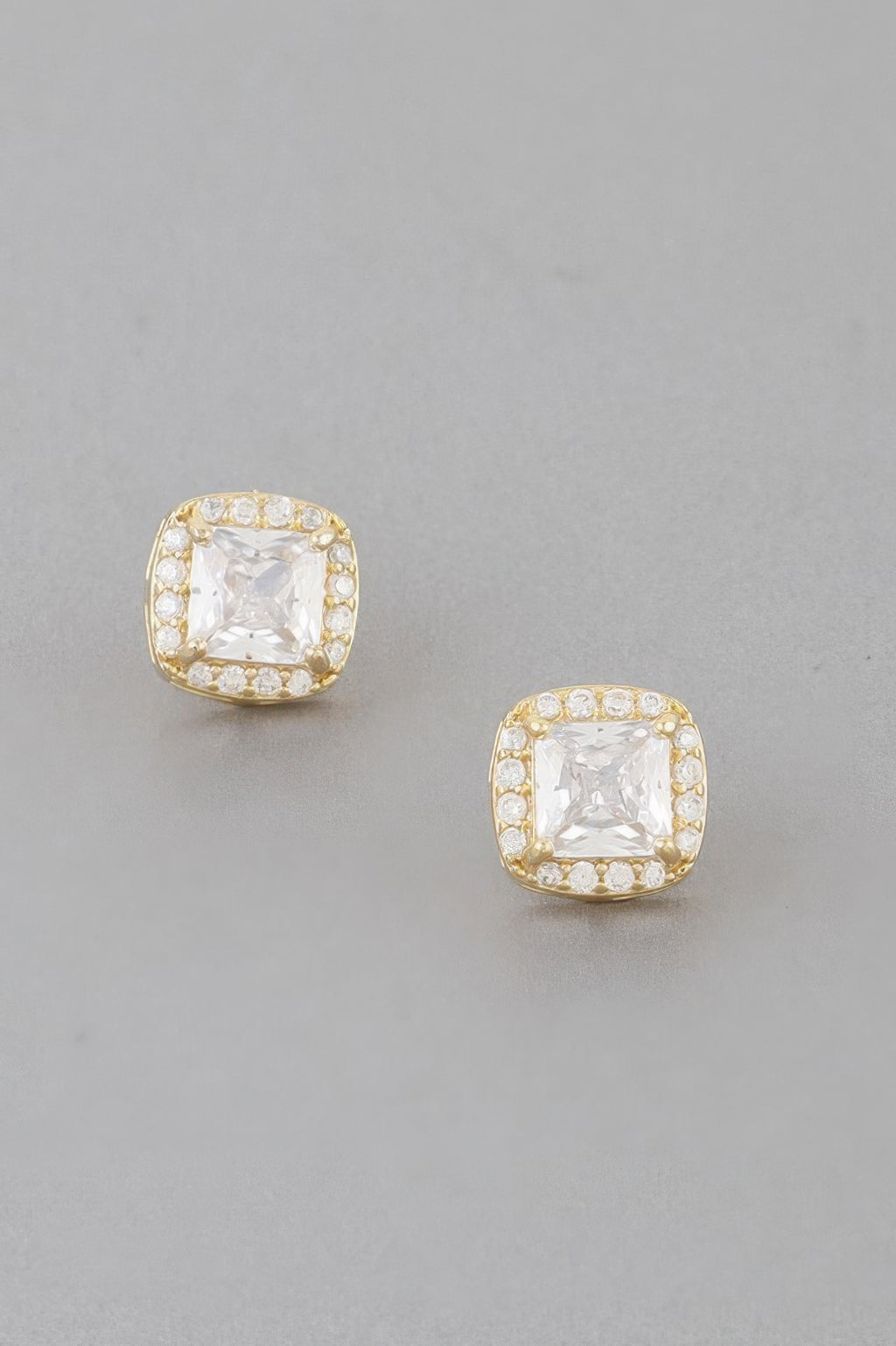 Gold-tone cubic rhinestone stud earrings with clear square center, matching pair