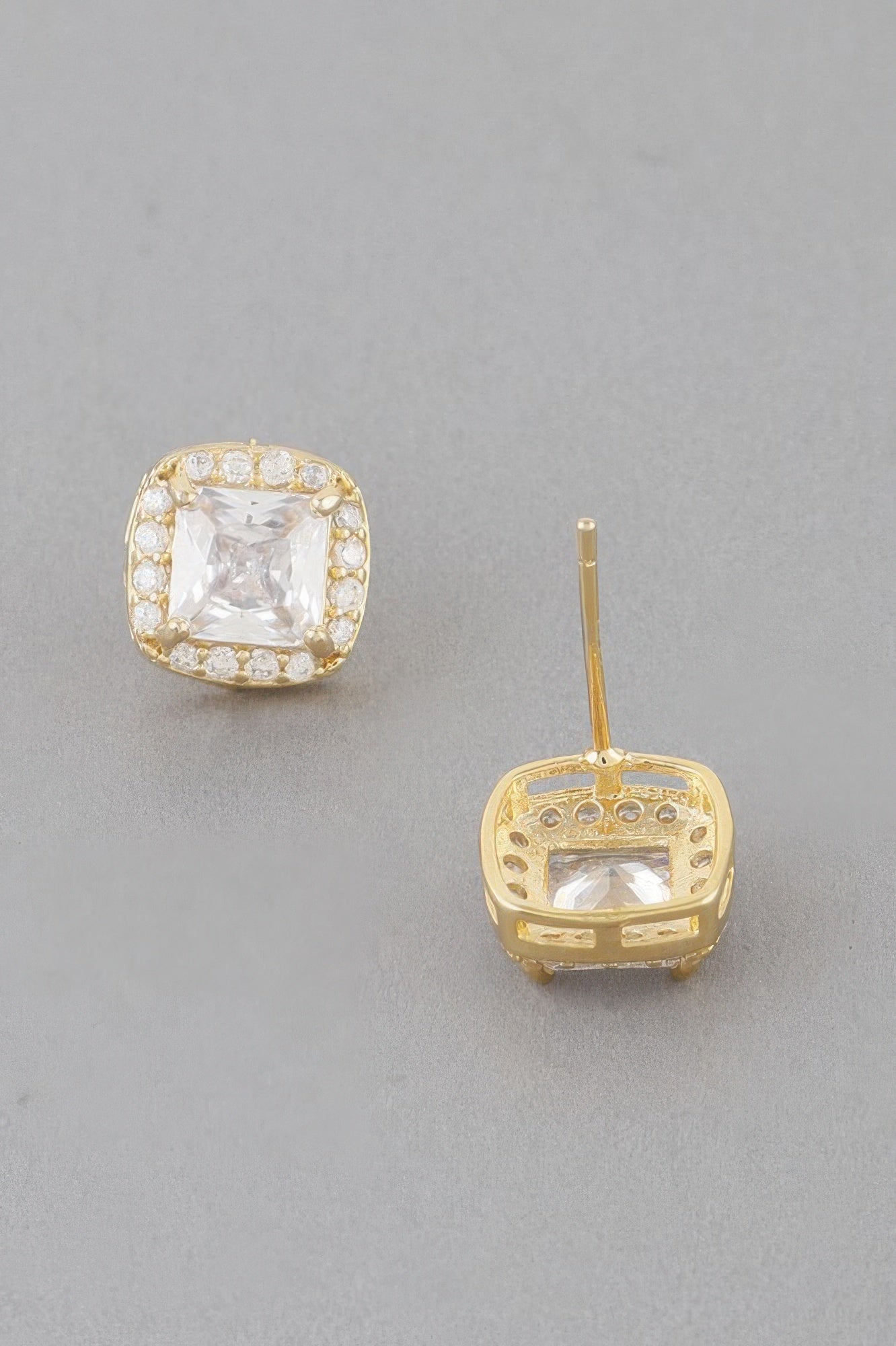 Gold-tone cubic rhinestone stud earrings with clear square center, post & setting visible