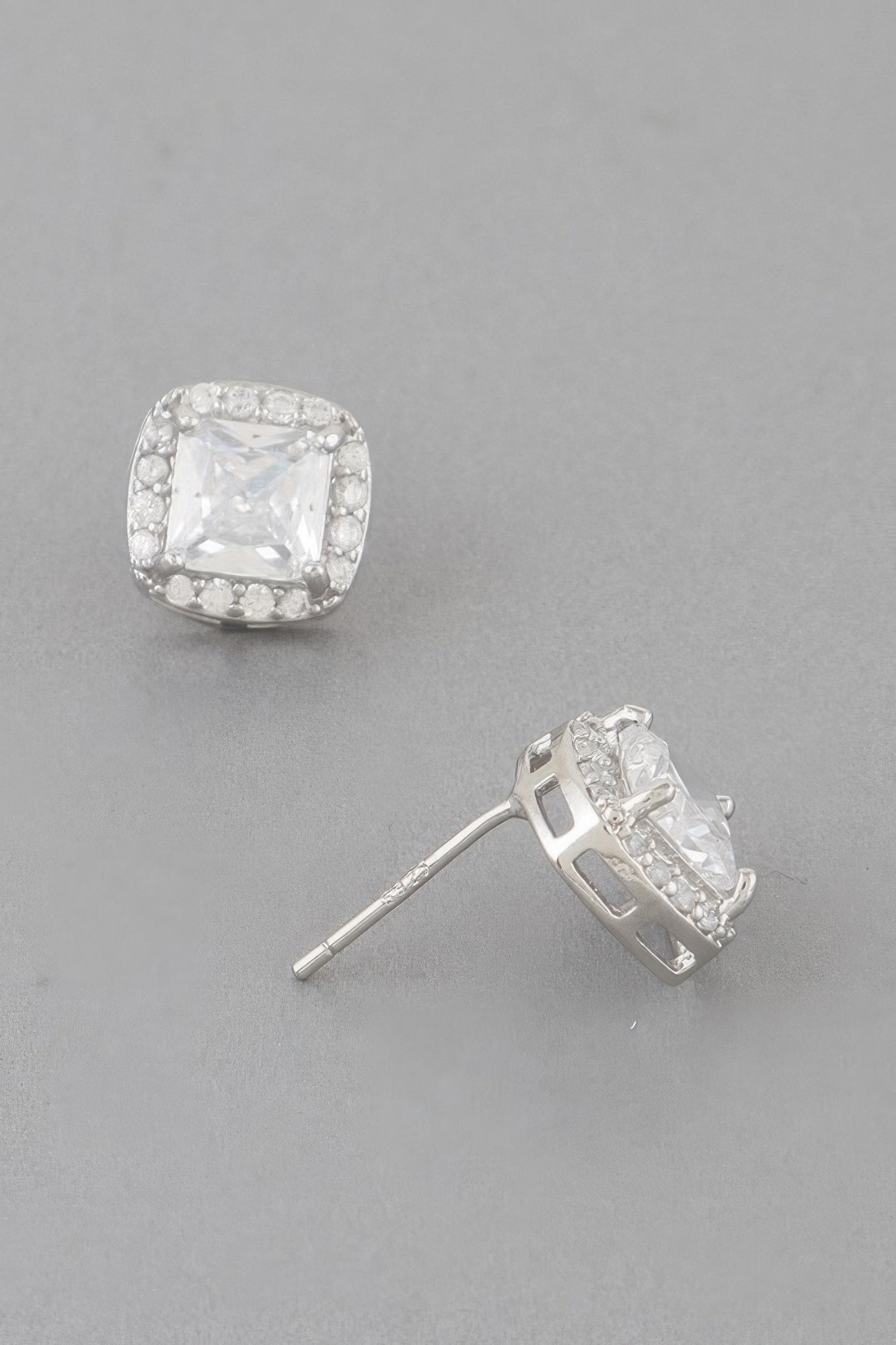 Silver-tone cubic rhinestone stud earrings with clear square center and sparkle halo