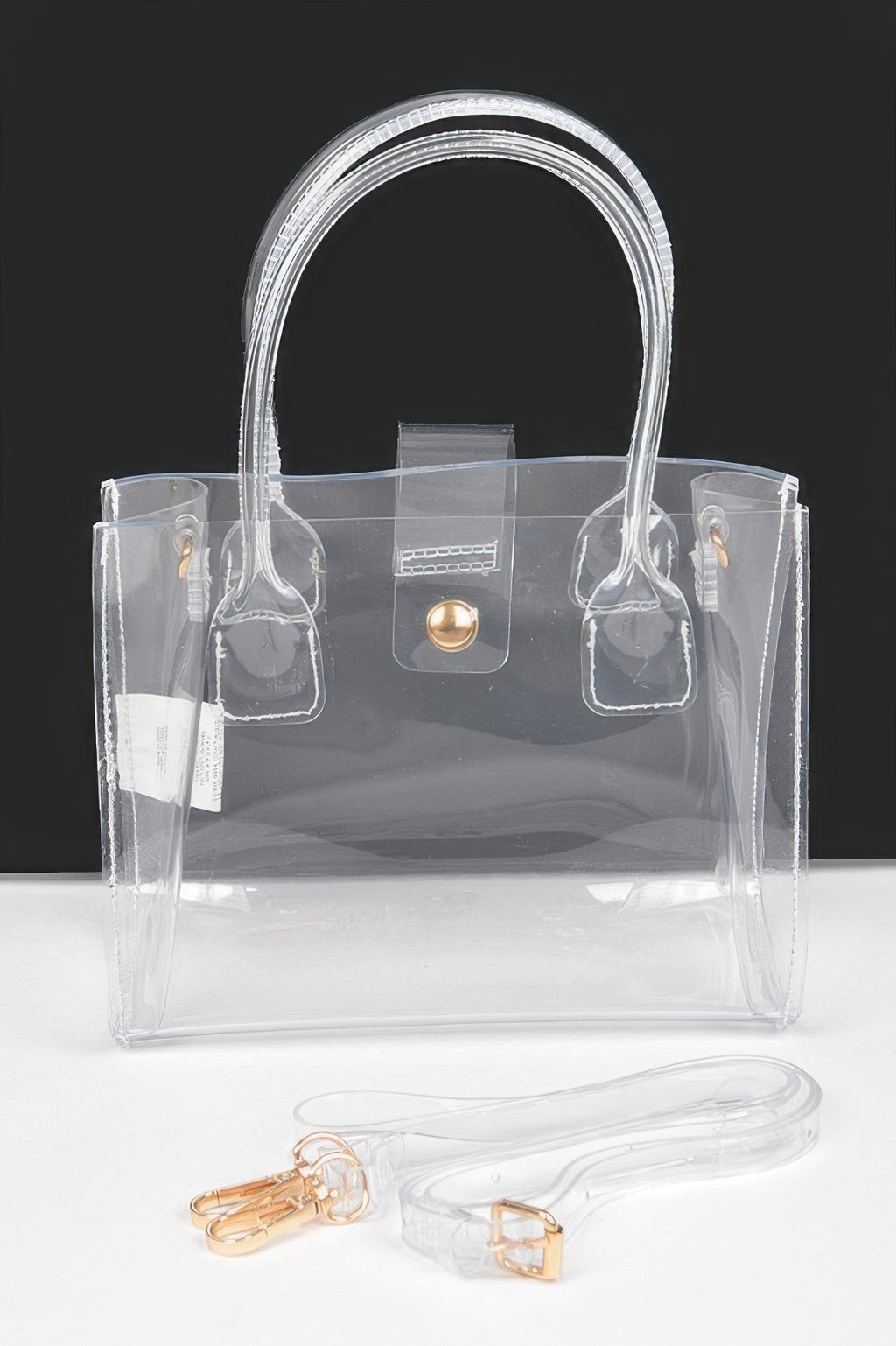 Transparent crossbody bag with gold-tone round clasp and double top handles