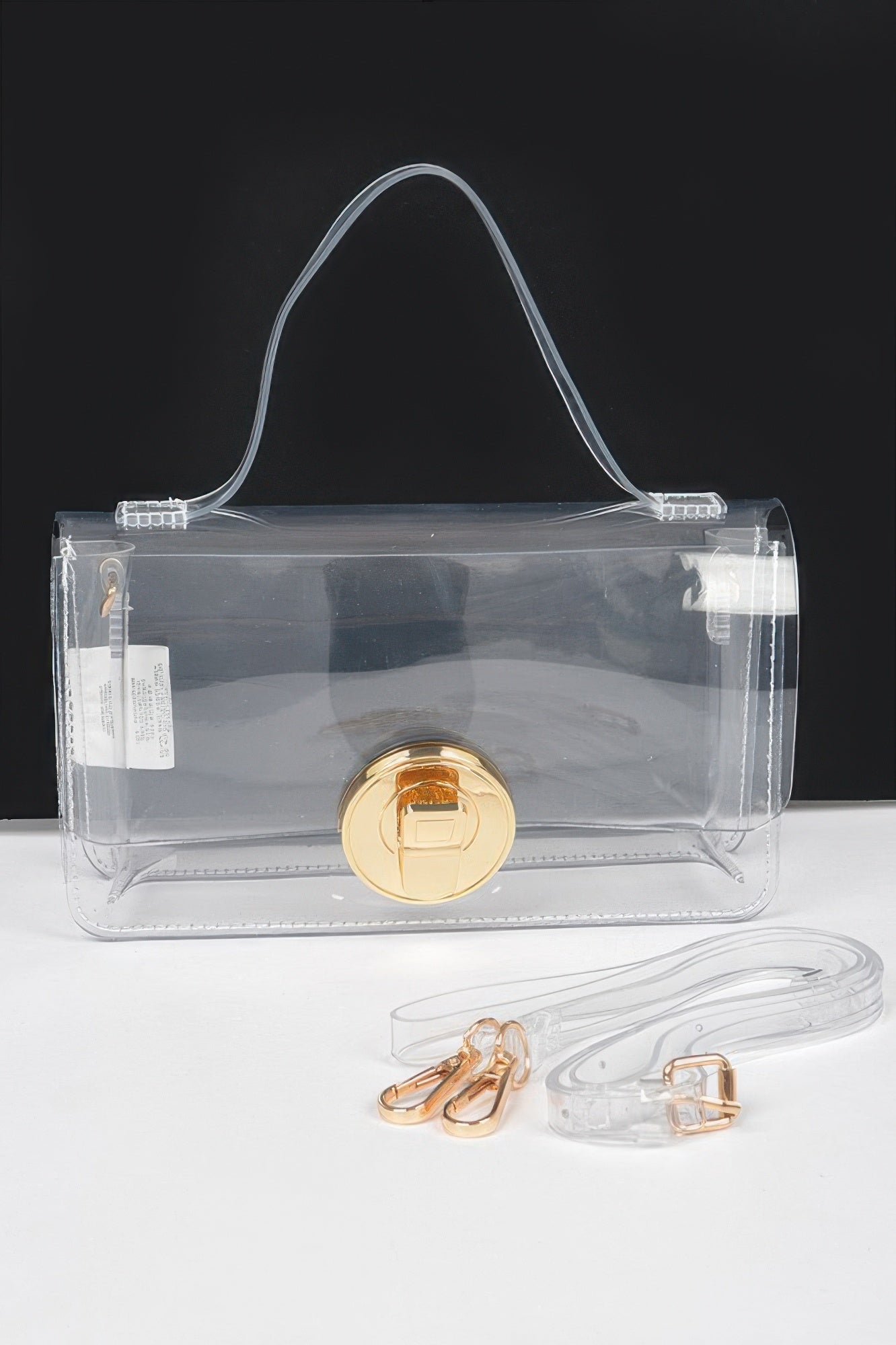 Clear gold transparent top-handle bag with front gold clasp and detachable strap
