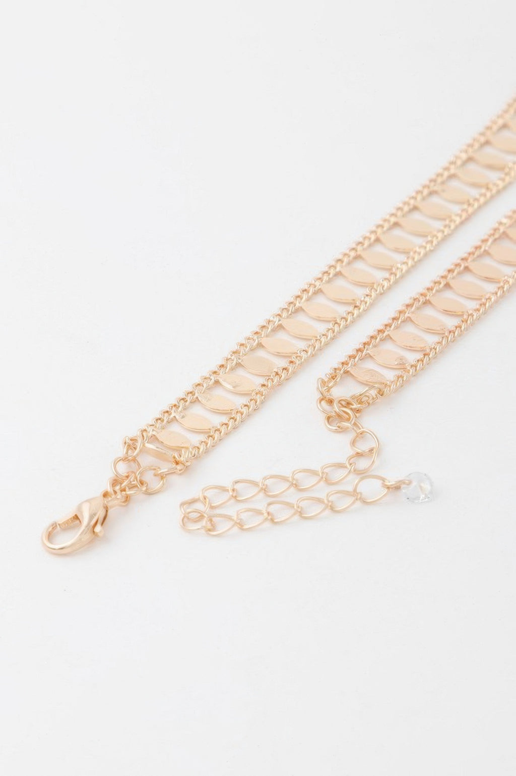 Close-up of gold leaf chain choker with clasp and extender chain