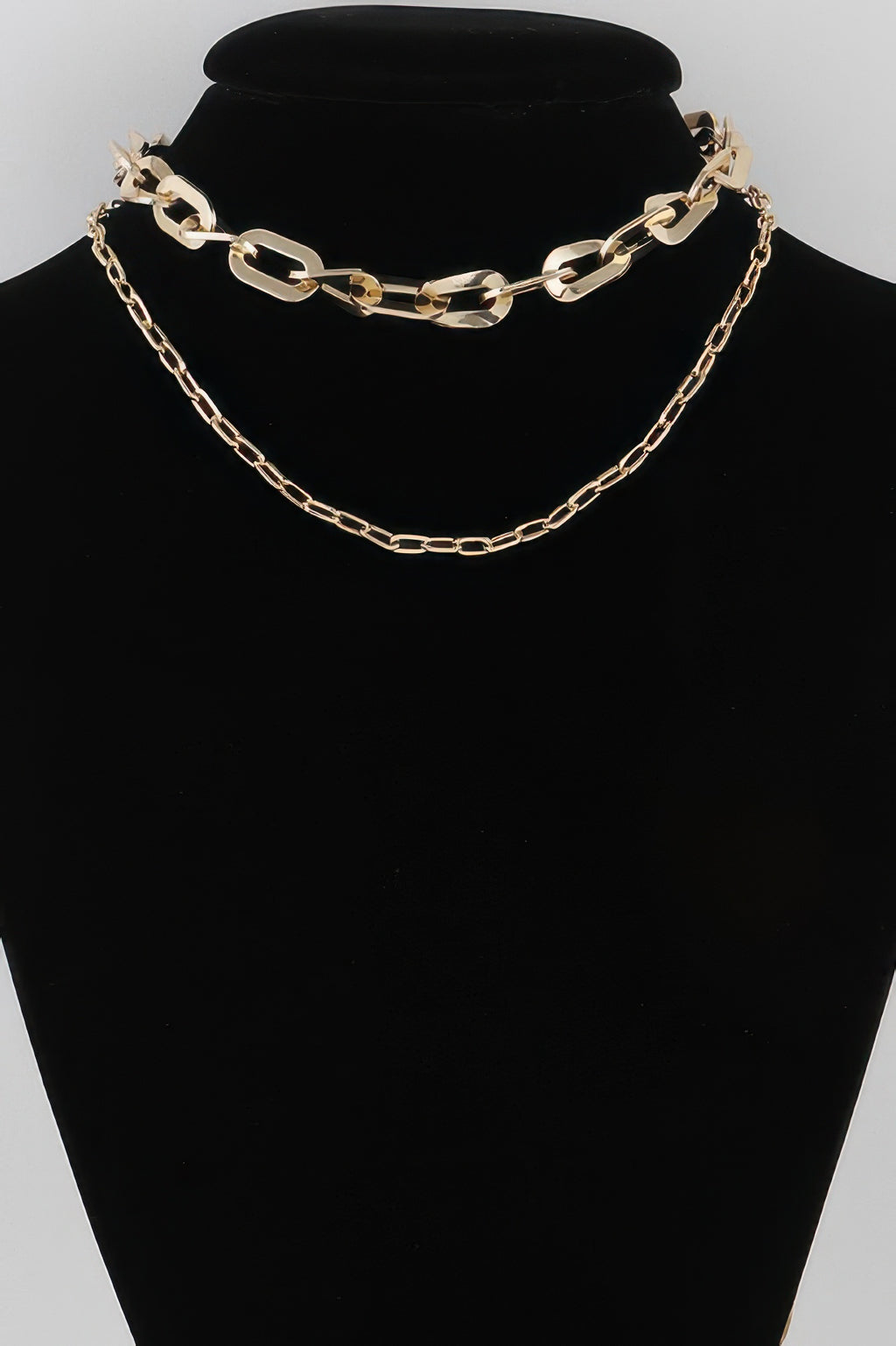 Double link chain necklace, gold-tone curb and oval links on a black display
