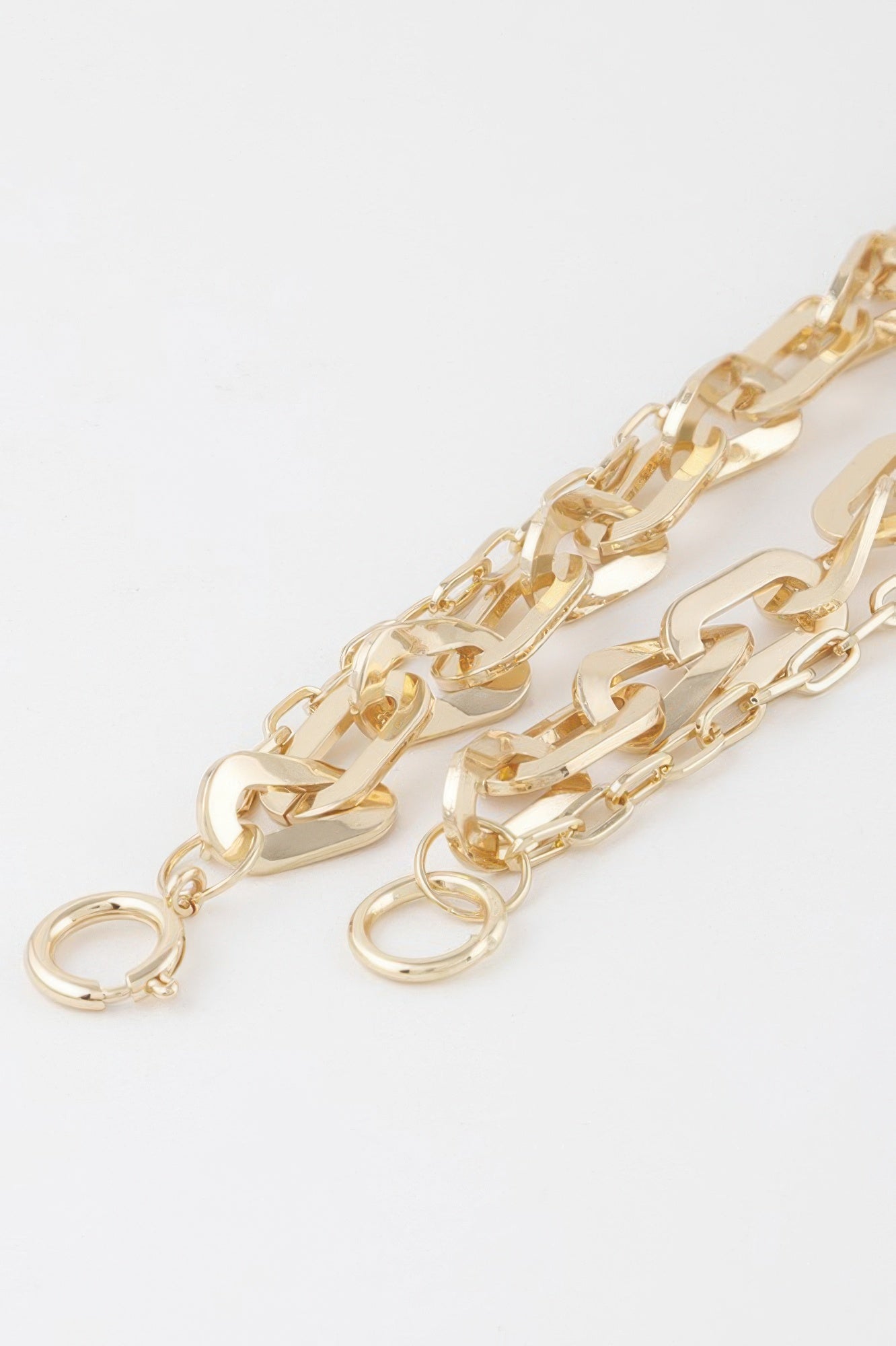Close-up of gold double chain necklace links with spring-ring clasp and extenders