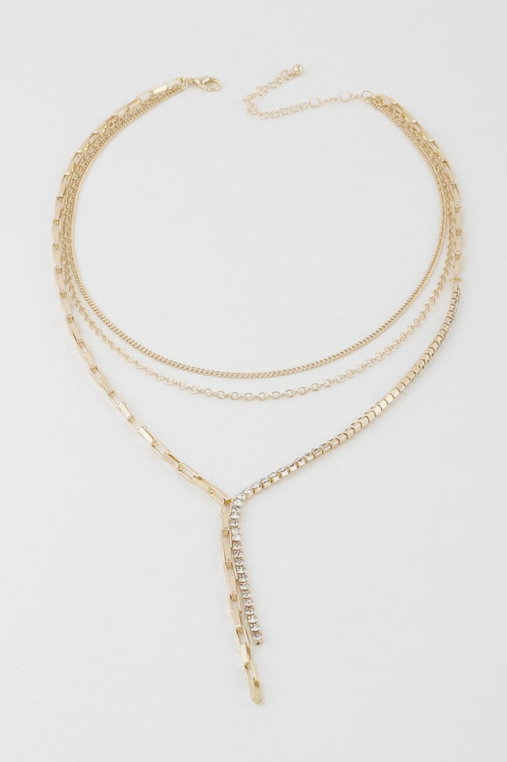 Gold-tone multi-chain necklace with oval rhinestone pendant and layered chain strands