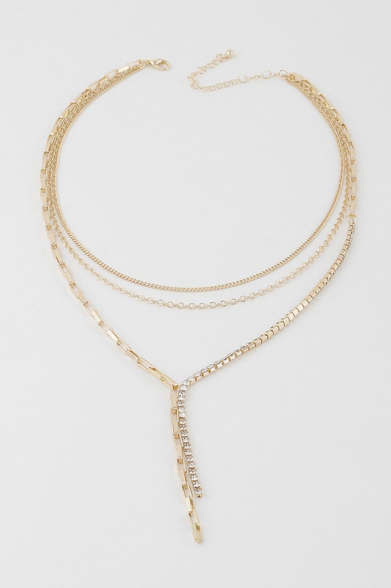 Gold-tone multi-chain necklace with oval rhinestone pendant and layered chain strands