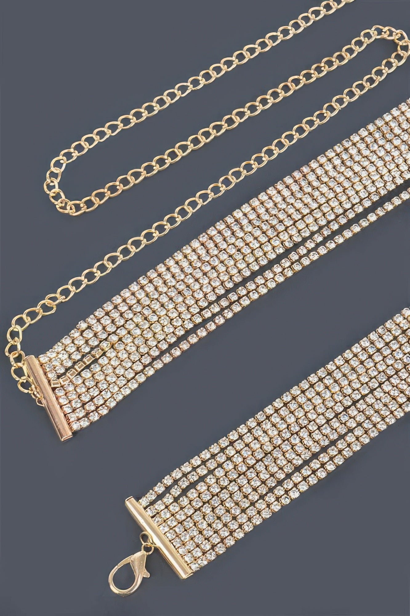 Gold rhinestone belt close-up: linked chain, clasp and bar centerpiece
