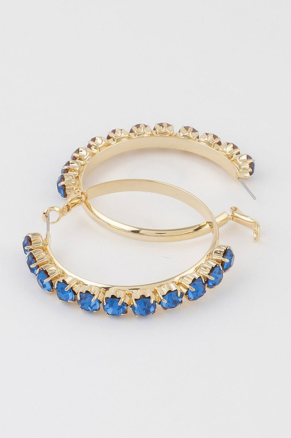 Gold hoop earrings with blue faceted stones along outer edge, clasp and post shown