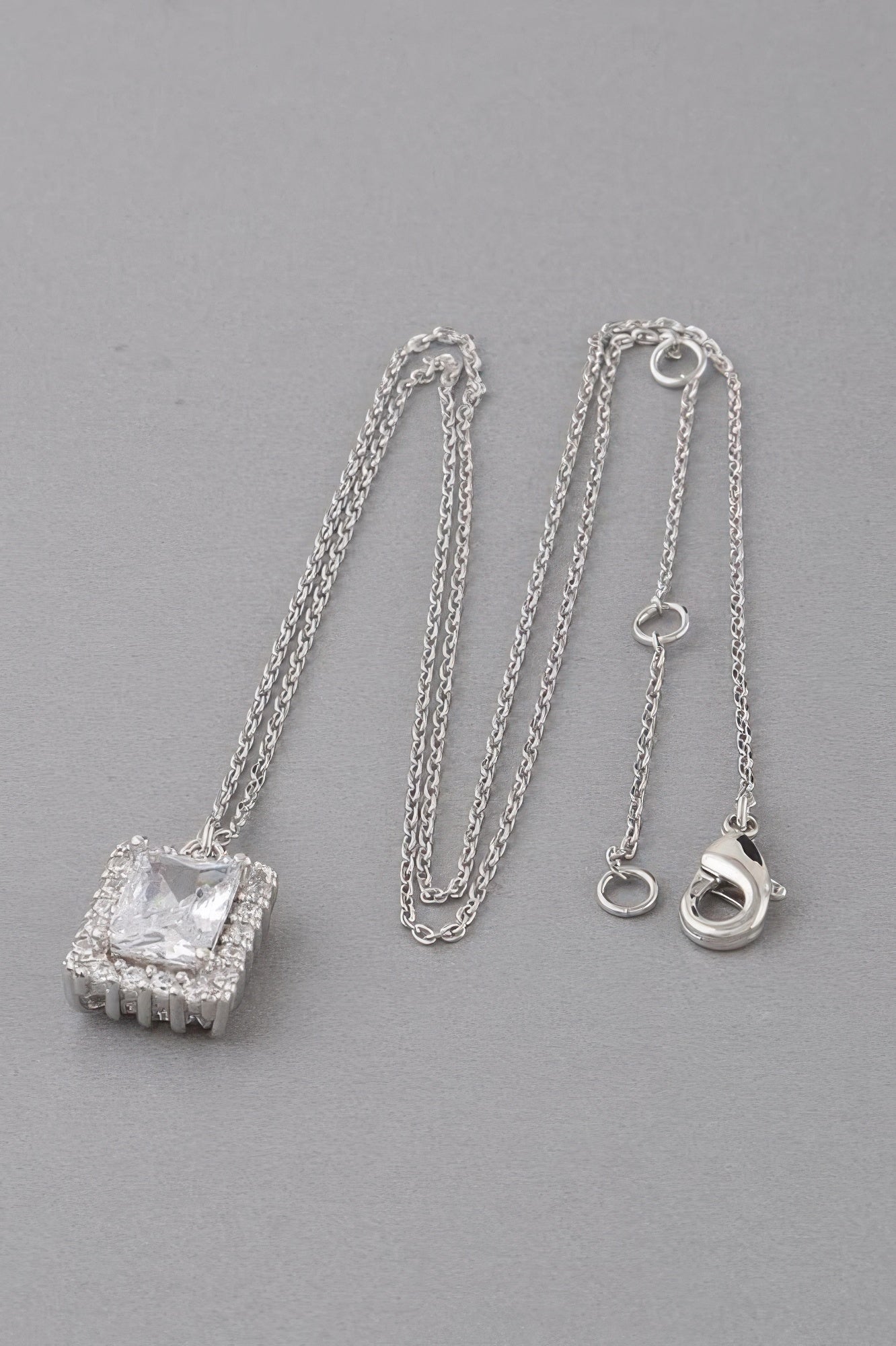 Framed rhinestone pendant necklace with clear stone pendant on silver chain