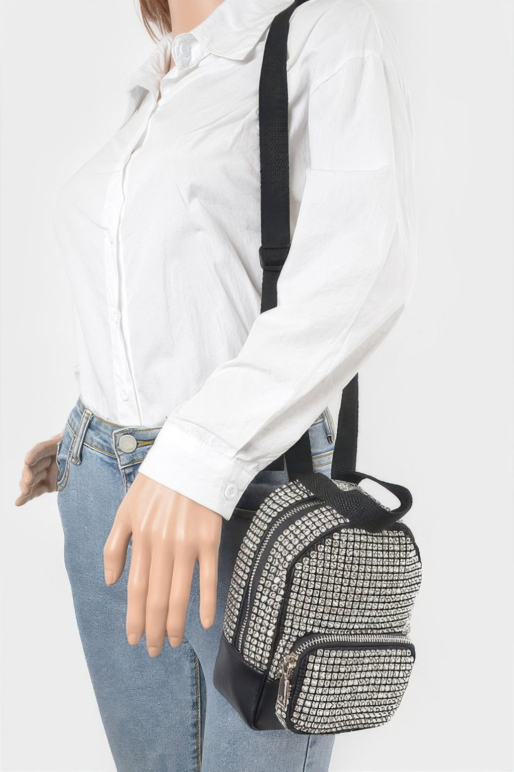 Rhinestone crossbody bag worn over shoulder, black base with clear rhinestone front