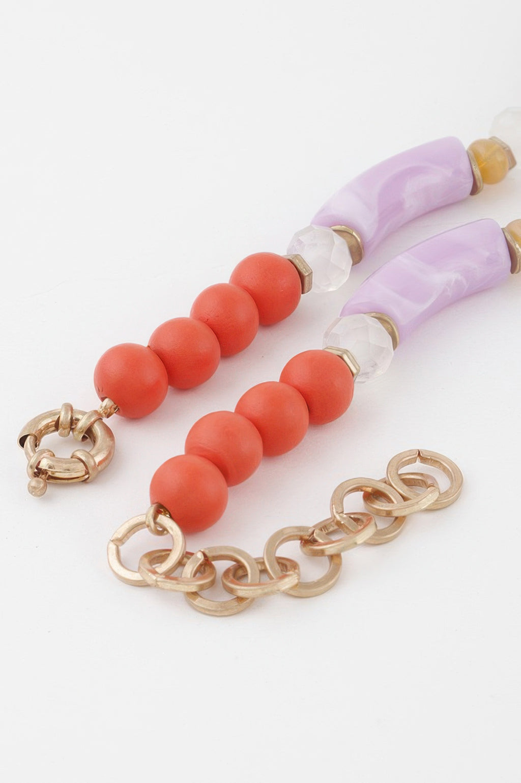 Flower marble bead necklace flat lay: lavender tube beads, coral round beads, chain