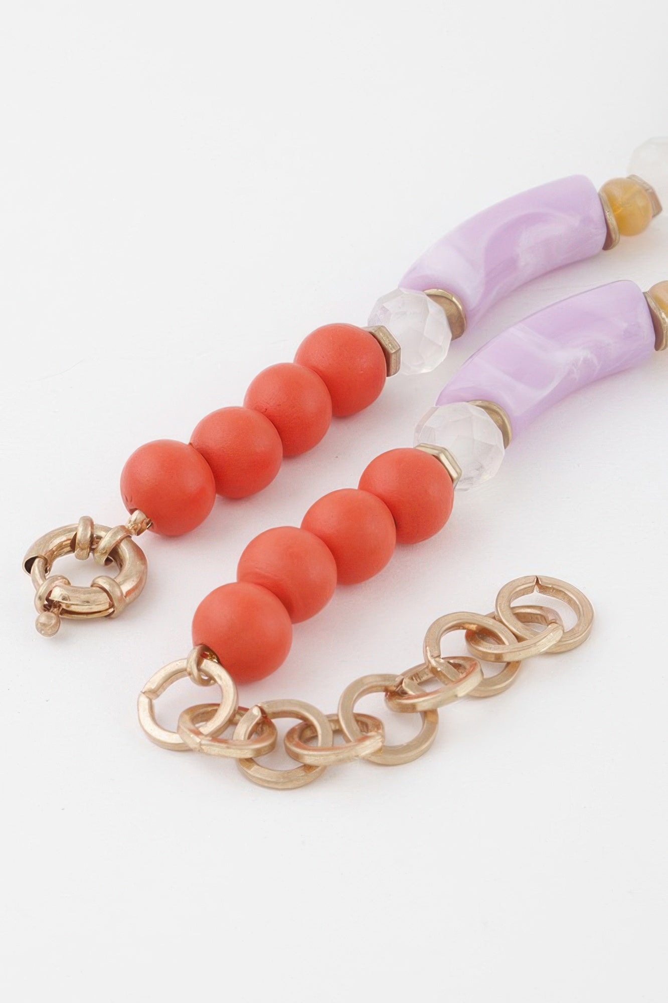 Flower marble bead necklace flat lay: lavender tube beads, coral round beads, chain