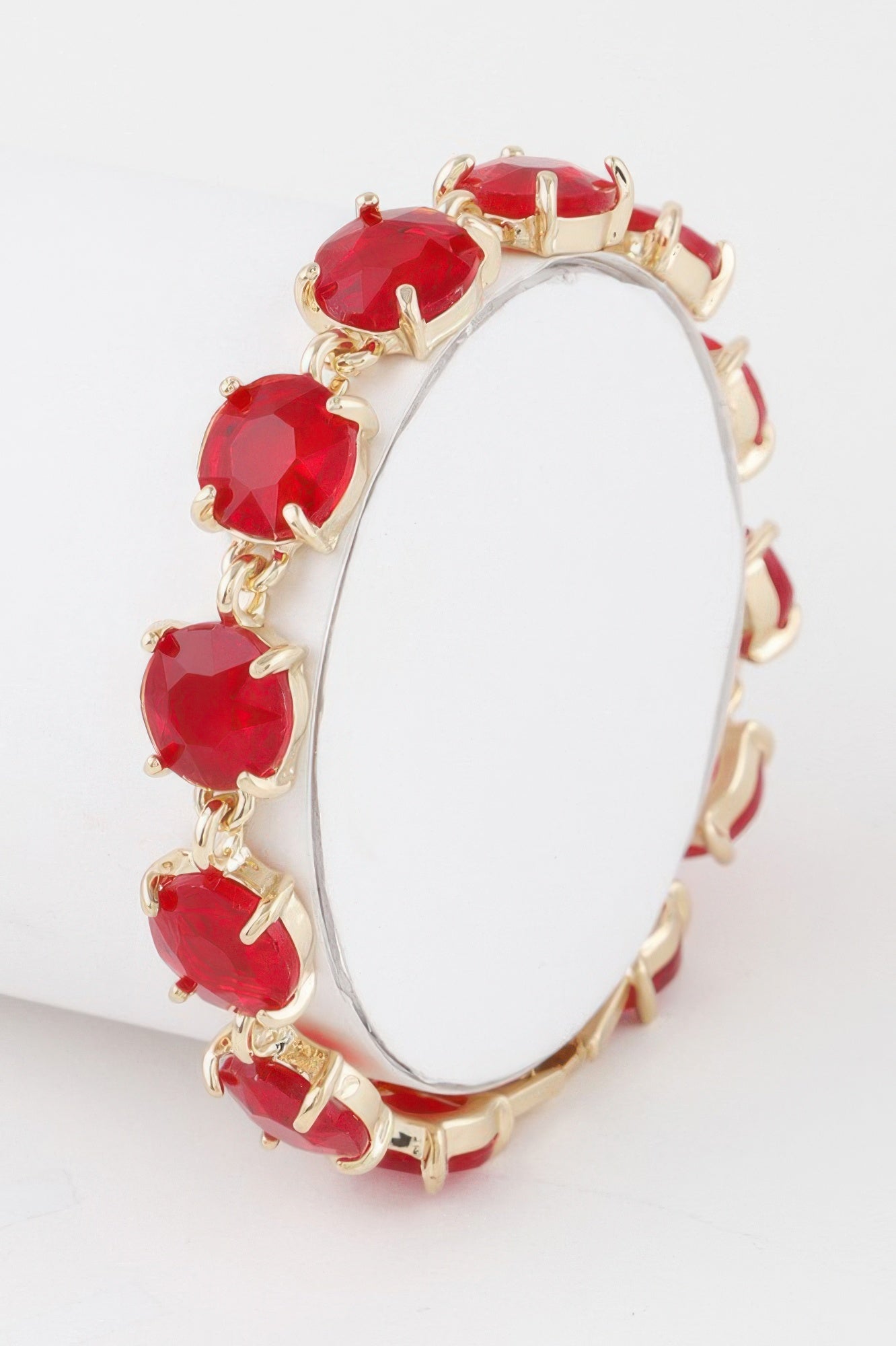 Crystal chain bracelet with red faceted oval stones and gold-tone links