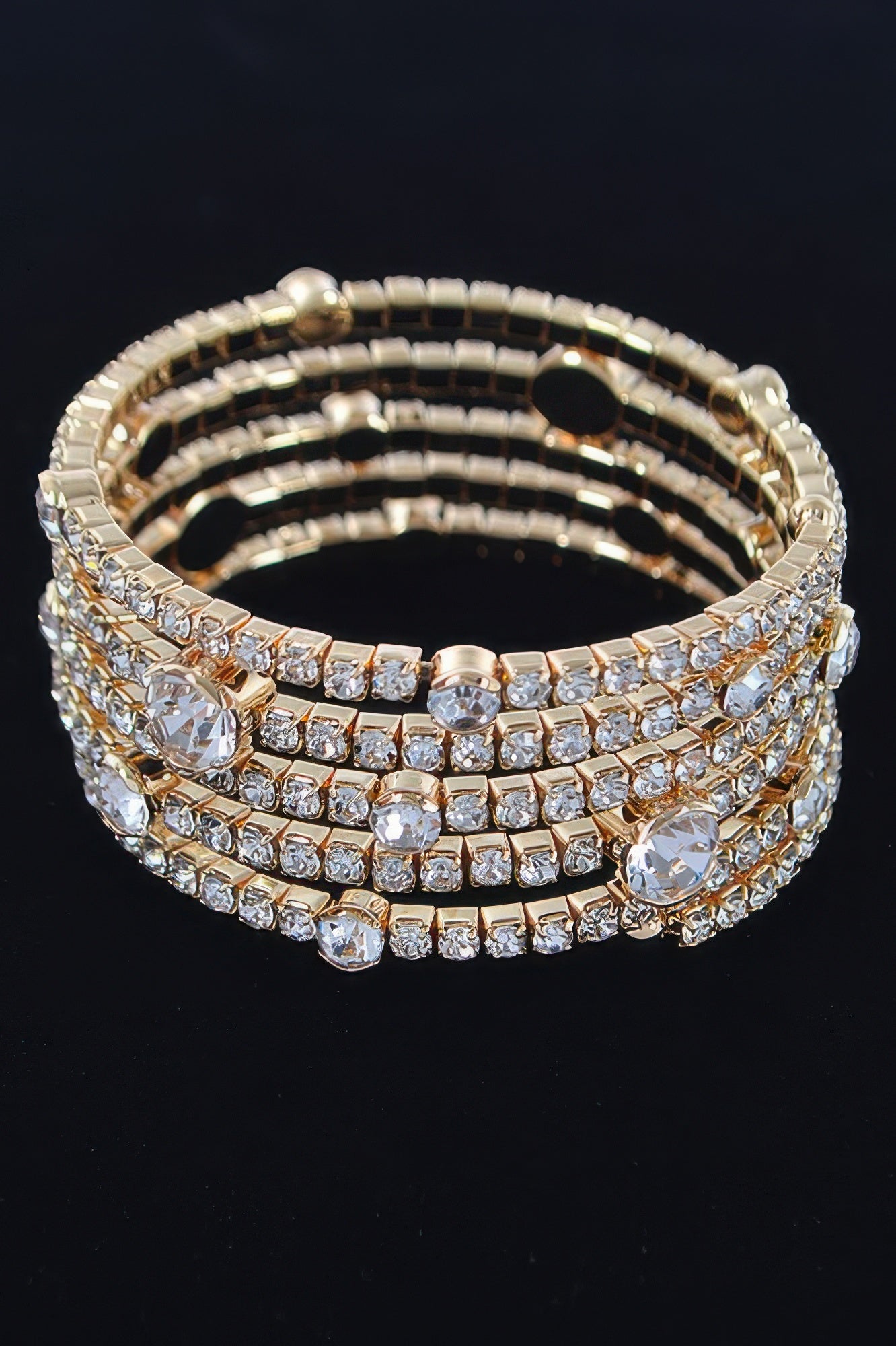 Gold rhinestone bangle bracelet featuring round crystal stones in stacked rows