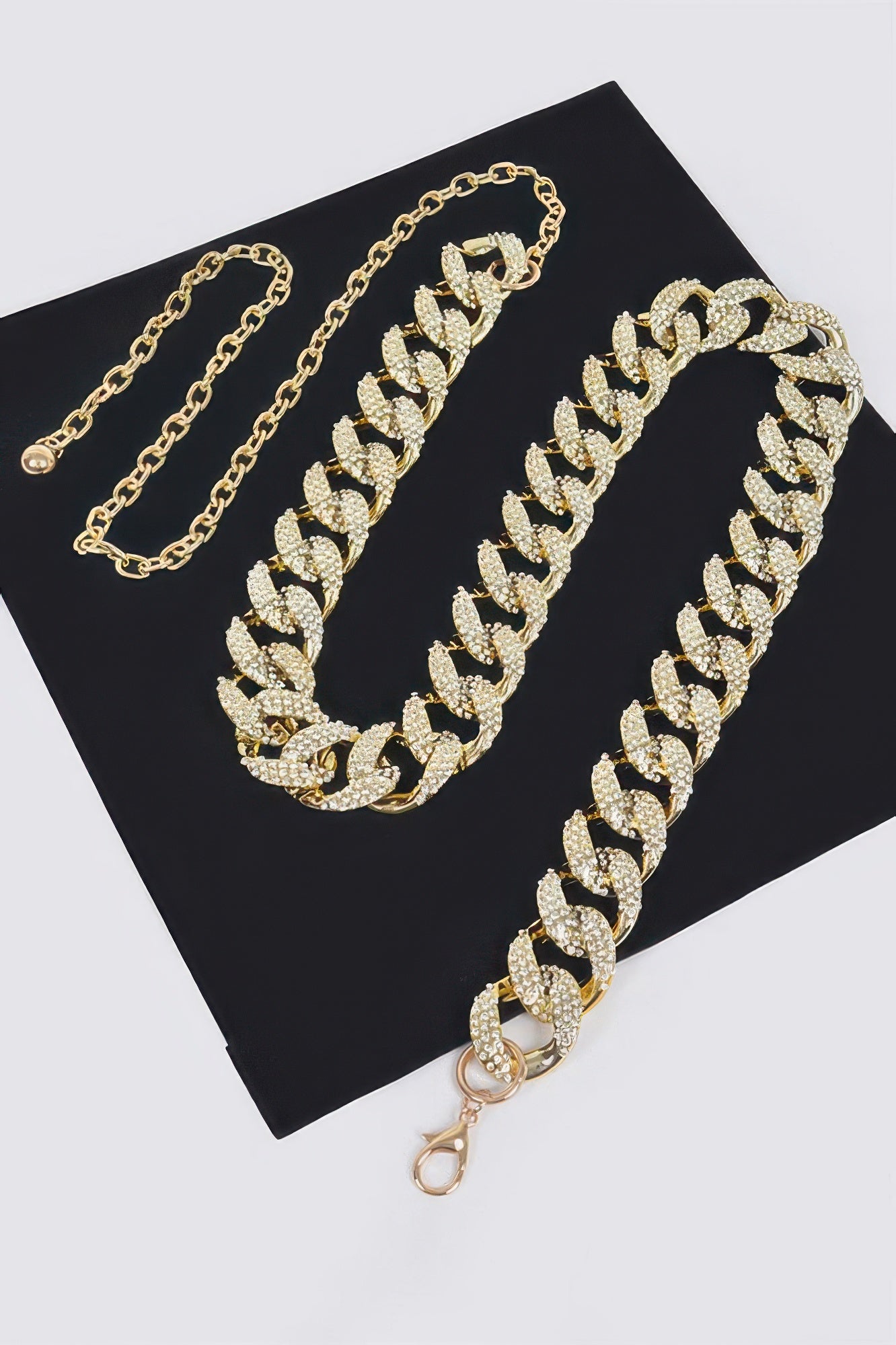 Gold-tone rhinestone chain belt with matching long chain and oval pavé links