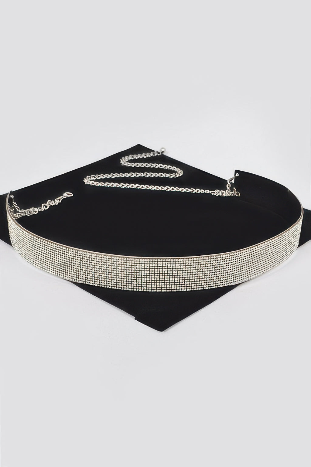 Gold rhinestone metal belt with chain links and clasp on black backing