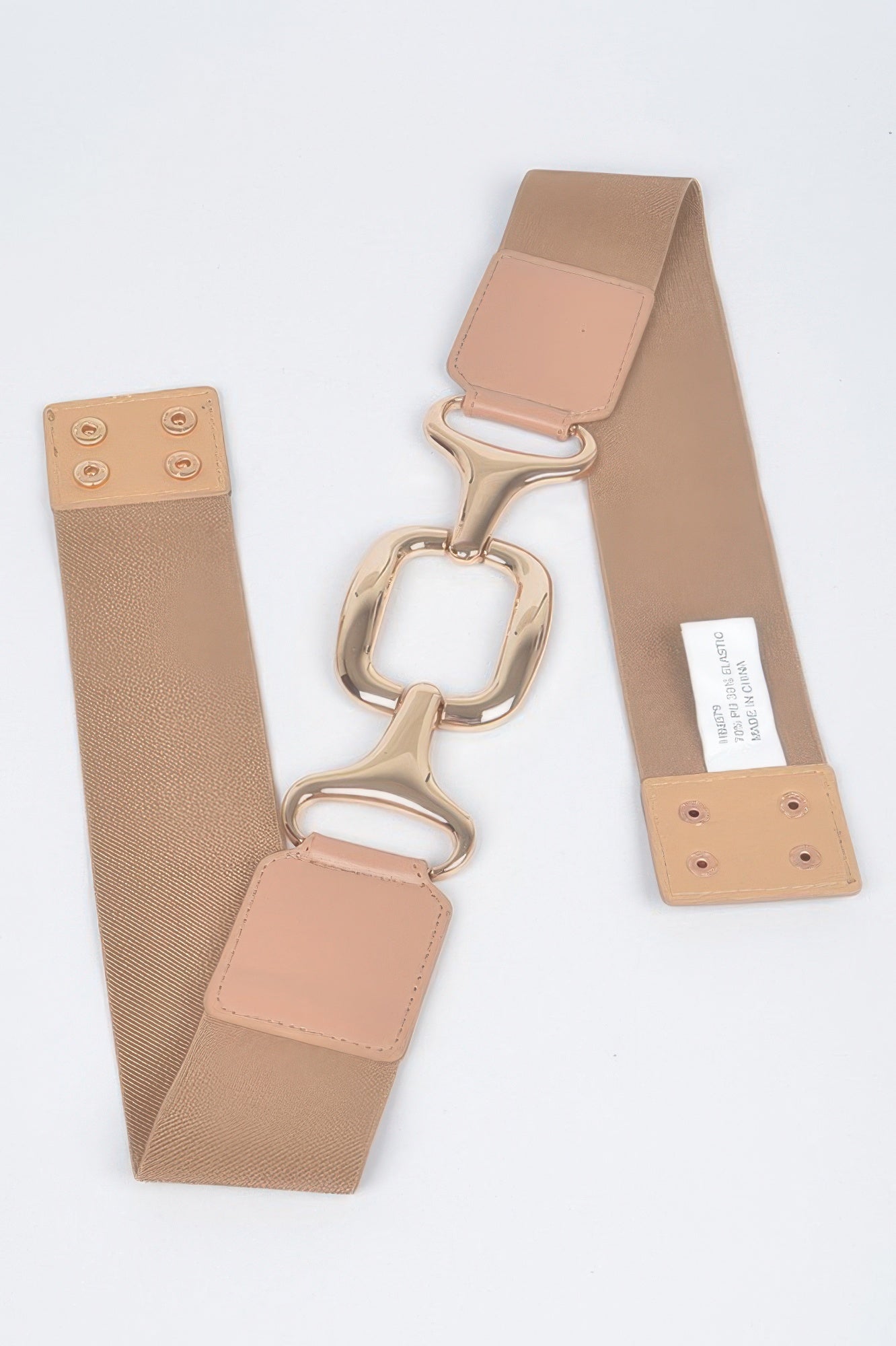 Nude multi-buckle stretch plus size belt with rose-gold hardware shown folded