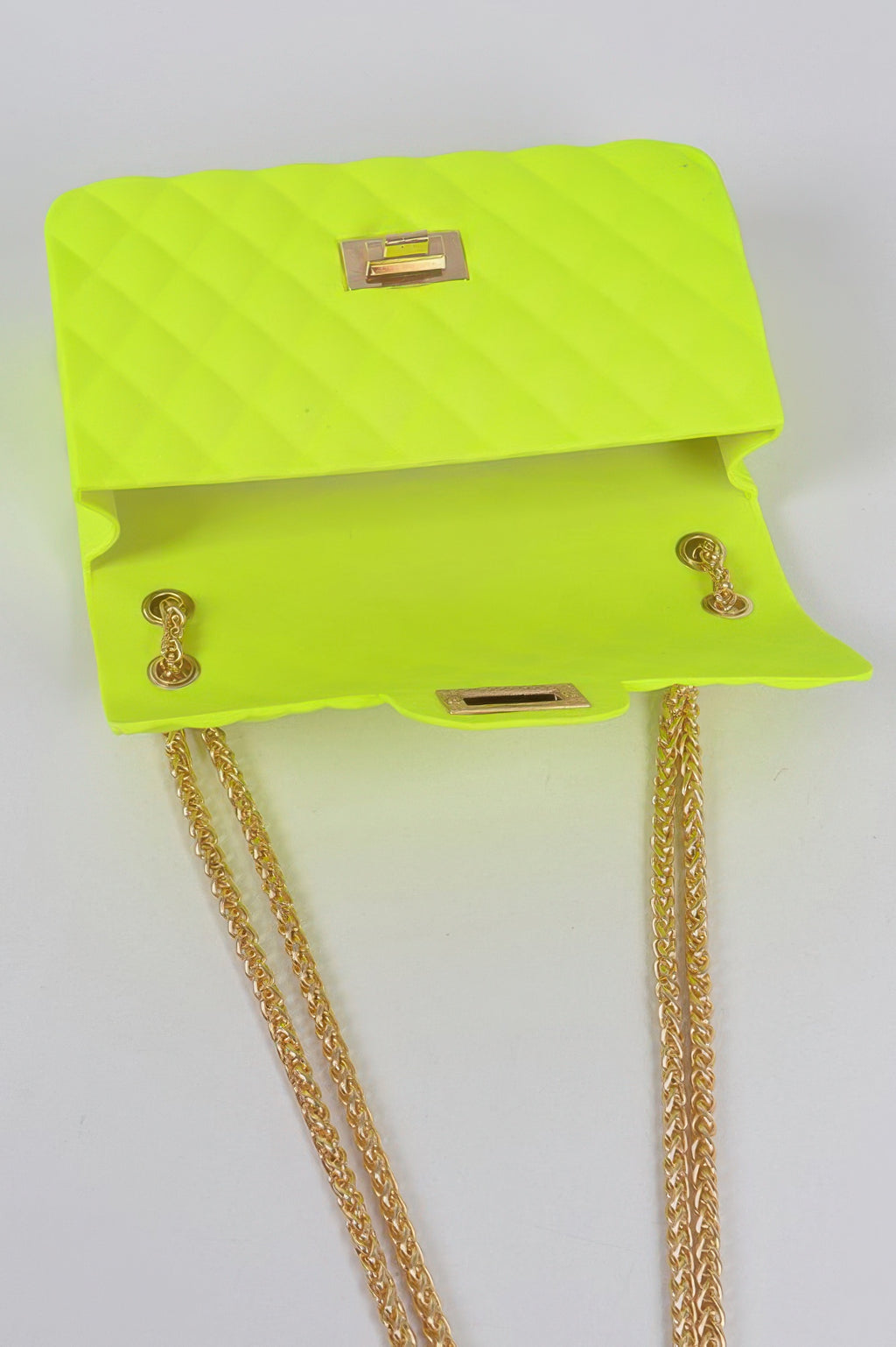 Neon green quilted clutch shown open, top flap clasp and gold chain
