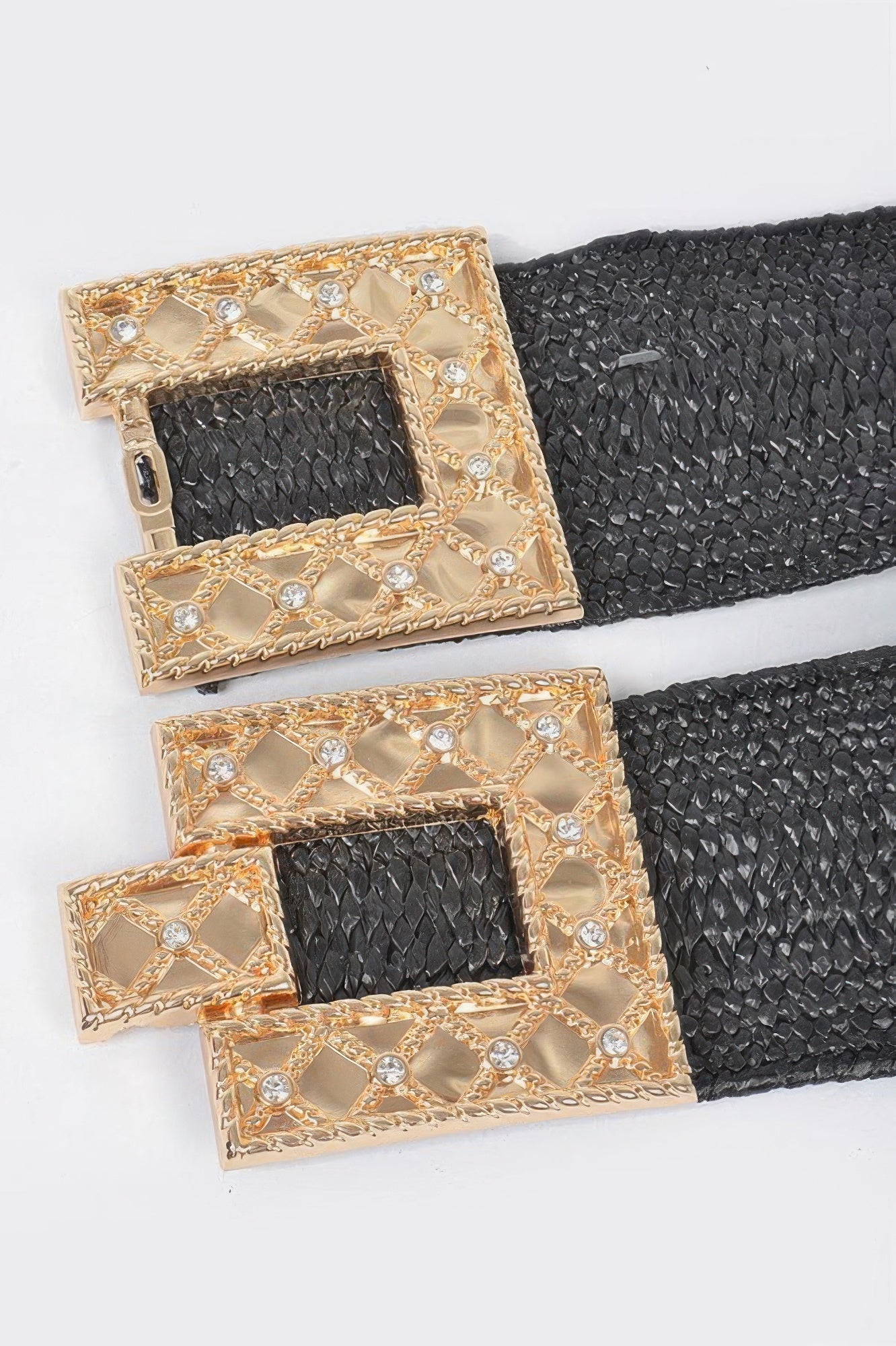 Close-up of black belt strap with gold rhinestone rectangular buckle details
