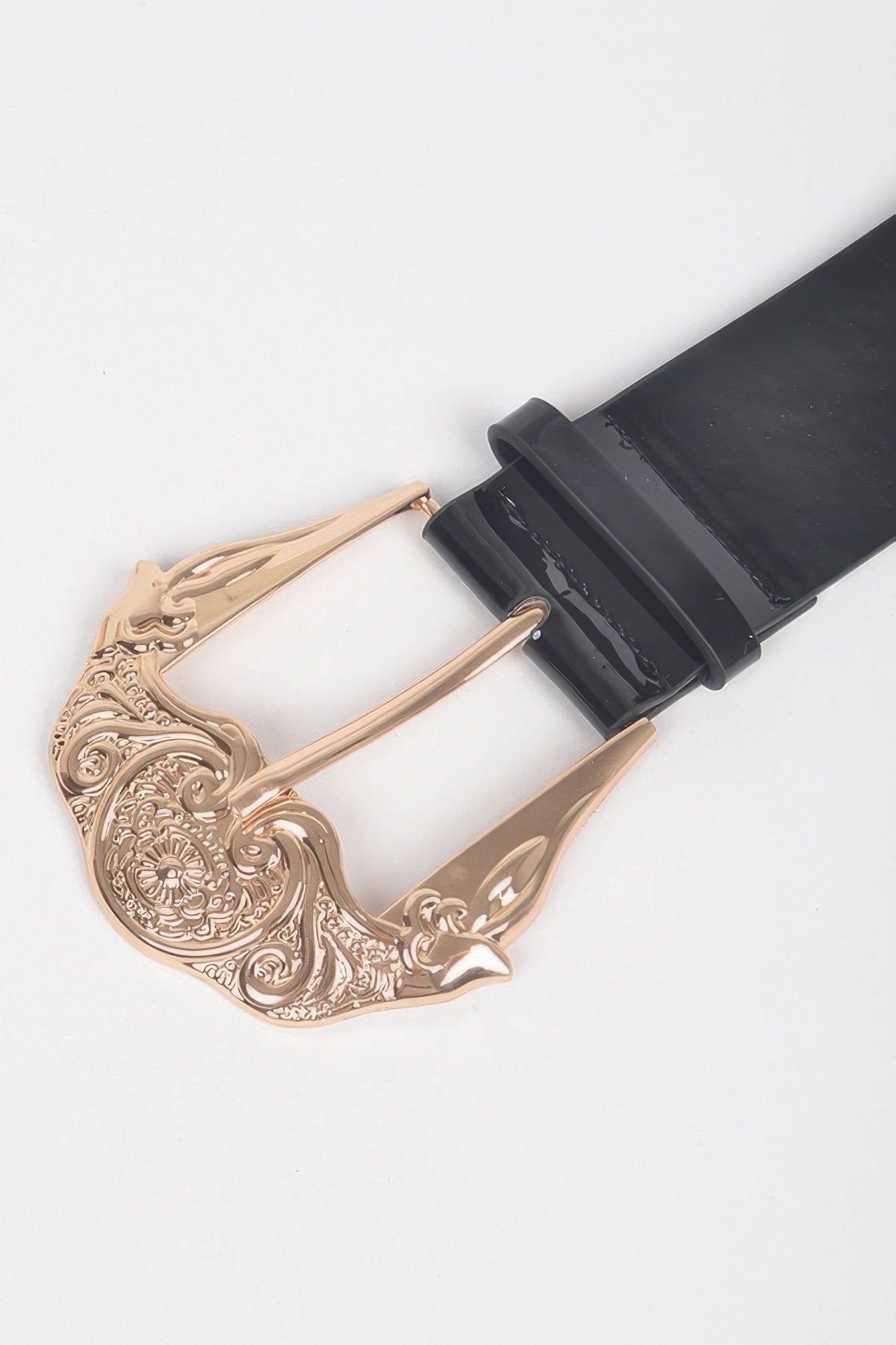Close-up of black enamel belt with ornate rose-gold buckle and adjustable strap